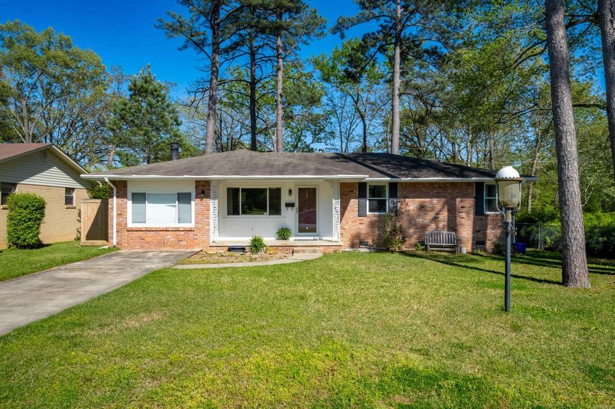 Charming & cozy 1 level brick home on quiet cul-de-sac. All appliances including refrigerator remain. Abundance of cabinet storage and small built-in desk top. Spacious kitchen-dining room, great room + bonus room. 3 BR & 2 full baths. There is a gas stove in the bonus room.  The bonus room has a separate private entrance. Hardwood floors in all areas except  bonus room, kitchen, baths & laundry room.  Separate laundry includes washer & dryer to remain.  No warranty on refrigerator, washer or dryer.  Laundry room/ mud room w/ doggy door.  Seller used the little shed in the back yard to raise a few chickens for fresh eggs. Level fenced lot at the end of the cul-de-sac. Move right in or be a great rental property -Convenient to medical facilities and shopping. (see agent remarks)