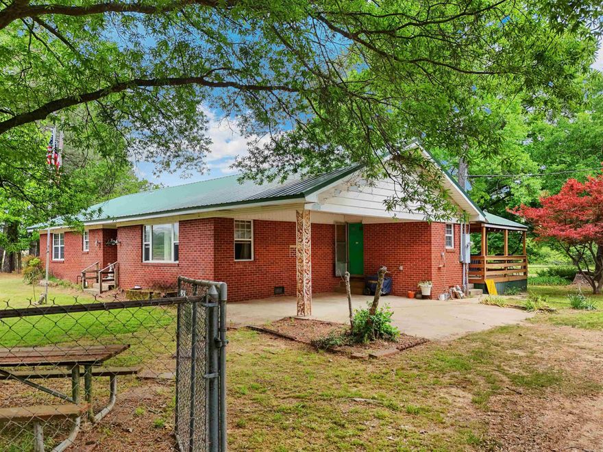 Opportunity awaits with this 3-bedroom, 1-bath brick home situated on approximately 10 beautiful acres! Being sold as-is, this fixer upper offers endless potential for investors, homesteaders, or buyers looking to create their dream country property. The home features a newer roof and hot water heater, giving you a solid start for renovations and updates.  Outside, the property is packed with amenities including a barn, two storage buildings, lean-to, cross fencing, a pond, and two wet weather creeks running through the land. There is also a concrete RV pad complete with its own electric meter, outlets, water line, and septic system — perfect for guests, additional living space, or RV hookup convenience.  With a mix of open space, water features, and functional improvements already in place, this property offers the rare chance to own acreage with tons of potential and room to grow. Be sure to check out the aerial drone video to catch a peak at all the wildlife! Agents see remarks.