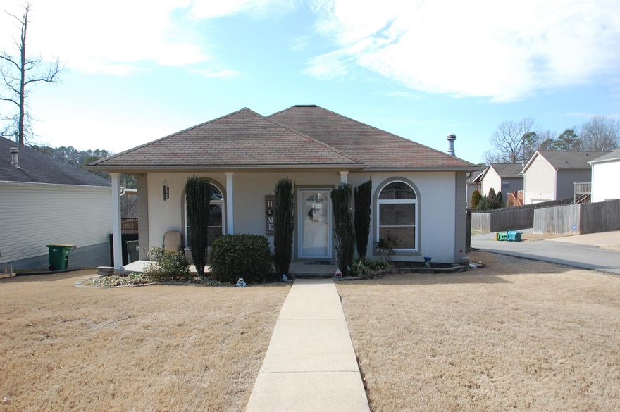 3 BR, 2 BA West Little Rock home on a corner lot. Nice landscaping. Open concept living/den area leading into kitchen/dining area with stainless steel appliances, & breakfast bar. Wood floors in bedrooms & tile in bathrooms. Primary suite w/dual vanities, walk-in shower, spacious closet plus a cedar lined closet. Primary suite has french doors that lead to a back deck that overlooks a fully fenced yard.  Split bedroom plan. Living area is all on 1 level with stairs that lead down to the rear entry 2 car garage. Utility room with cabinets.