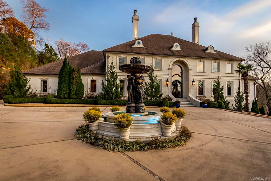 Lakefront Masterpiece! This gorgeous custom-built home sits on 5.5 stunning acres. This 4-story estate has it all!! Gated entrance, 2 private boat docks, salt-water pool, grotto, waterfall, outdoor kitchen, veranda, indoor basketball court, theater, sauna, safe room, arcade, tanning room, massage room, gym, wine cellar, library, and elevator. Each of the stately 5 bedrooms has an ensuite for a total of 6 full-baths and 2 half bathrooms. The Chef's kitchen is equipped with state of the art appliances and features. Multiple security features throughout the home. Come see this one of a kind BEAUTY!