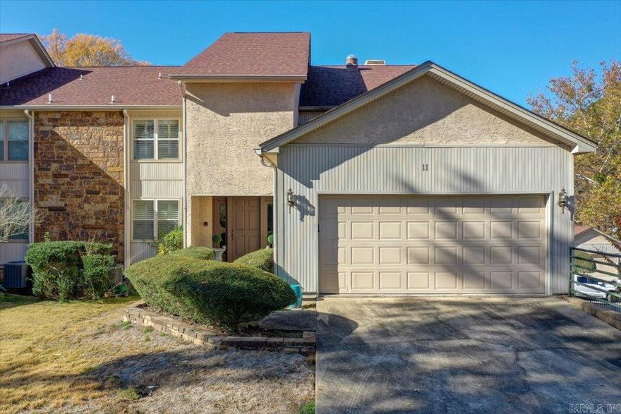 LOCATION, LOCATION, LOCATION! and MOVE-IN READY.  Williamswood is an exclusive 12-unit townhome gated community on beautiful Lake Hamilton.  This complex has lots of mature trees and open grass areas at the front of the complex making this a peaceful and quiet oasis.  Unit #11 has all the upgraded features-custom cabinetry, built-in's throughout, and granite countertops in the kitchen.  Main floor features open concept kitchen, dining, and living room featuring a wet bar and large buit-in, 2 generous size bedrooms, one with an ensuite, and a guest bath.  Upper level has additional den with large master bed and bath.   Spacious upper and lower decks make the outdoor space plentiful for relaxing or entertaining. When you are ready to get on the lake, the covered boat slip is just a short walk from the unit.  Location cannot be beat, minutes from shopping, dining, Oaklawn racing resort, historic Central Ave and downtown.  Don't miss out on this lake property!  Agents, see remarks.