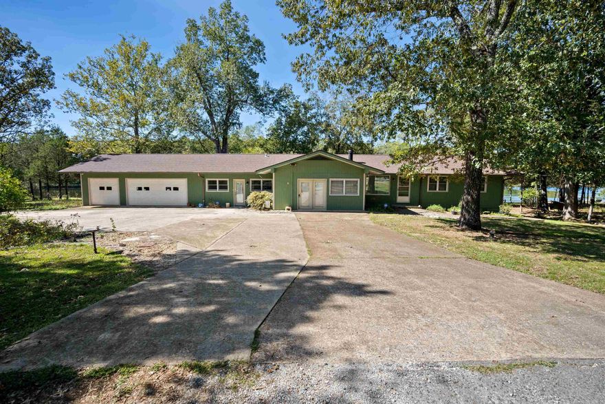 Discover your own private lakefront retreat with 4 total lots, including 3 beautiful lakefront lots offering stunning views and peaceful seclusion at the end of a private cul-de-sac. This spacious home features 4 bedrooms and 3 baths, including a large primary suite with its own covered deck overlooking the lake. Enjoy relaxing mornings and sunsets surrounded by nature. The main level offers a welcoming living and dining area that open to a deck with lake views. The basement includes a bedroom with walk-in closet, a shower room, and a large storage area. Outside, you’ll find a gorgeous rock water wall, hidden flower beds ready to bloom in spring, and plenty of room for lakeside fun. A 3-car garage adds convenience and storage. With its level lots, natural beauty, and unmatched privacy, this property is the perfect blend of comfort and lakefront living. This property combines seclusion, scenic beauty, and functional living space in one of the area’s most desirable settings. Schedule your private showing today — lakefront living doesn’t get better than this!