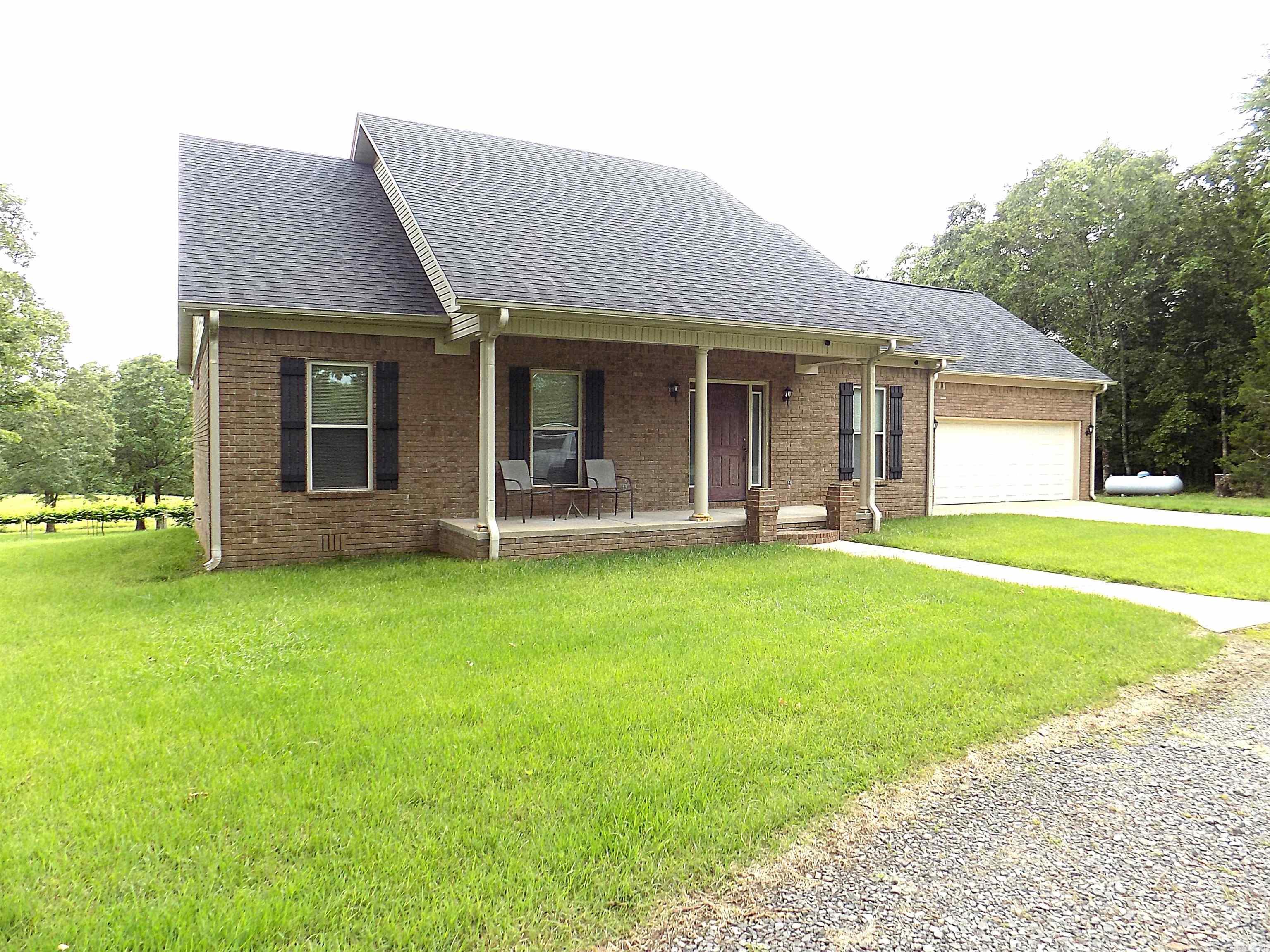 Looking for quiet country living, this is it. Relax on the back porch with a view of your 20 acres and a vineyard. Bonus room up stairs has lots of storage and could also be a 5th bedroom. Home has energy features such as a Generator that kicks on when the electric stops.Wood burning Fireplace that is vented in the duct work. Propane tank is owned by seller. 2 hot water tanks. 9ft Tall ceilings throughout with main bedroom having double pan ceilings,garden tub and walk in shower. Pantry is off the kitchen in the laundry room. eat in kitchen and formal dining room. Large circle drive with lots of parking. SHOP 30x45,16x8wood shed and a storm shelter. located 2/10 of a mile off HWY 225