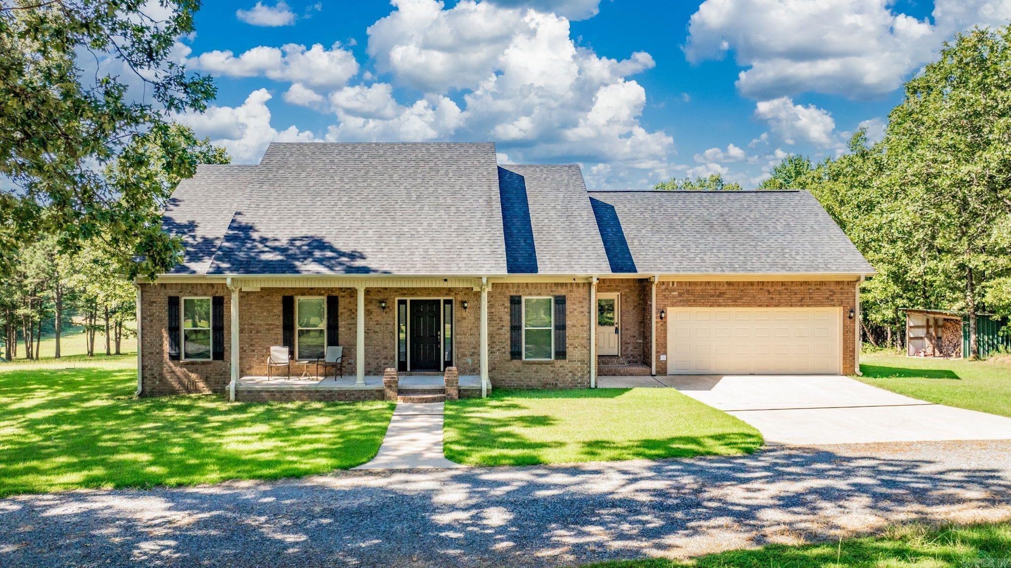 Looking for quiet country living, this is it. Relax on the back porch with a view of your 20 acres and a vineyard. Bonus room up stairs has lots of storage and could also be a 5th bedroom. Home has energy features such as a Generator that kicks on when the electric stops.Wood burning Fireplace that is vented in the duct work. Propane tank is owned by seller. 2 hot water tanks. 9ft Tall ceilings throughout with main bedroom having double pan ceilings,garden tub and walk in shower. Pantry is off the kitchen in the laundry room. eat in kitchen and formal dining room. Large circle drive with lots of parking. SHOP 30x45,16x8wood shed and a storm shelter. located 2/10 of a mile off HWY 225