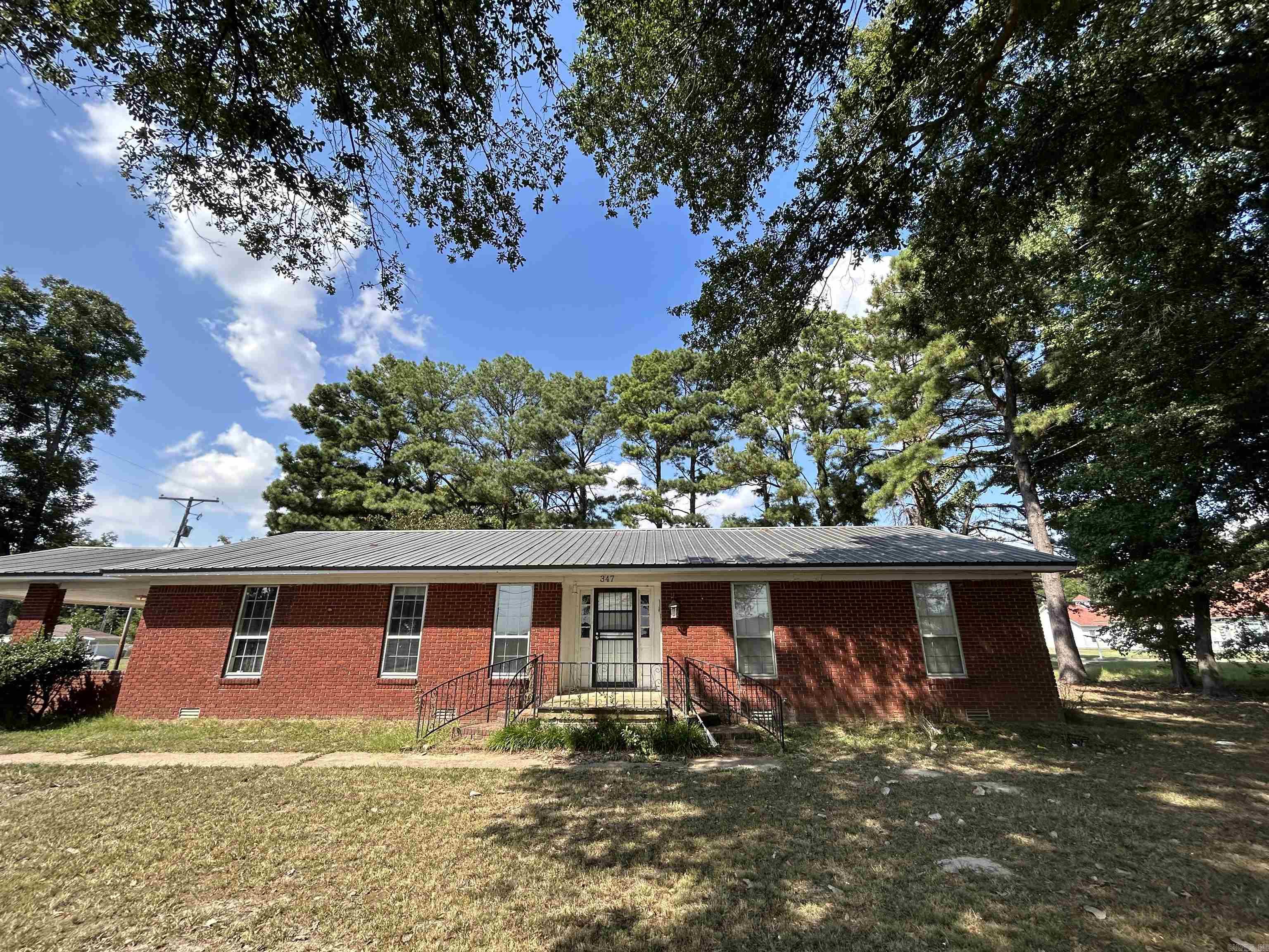 This great home featuring new floor covers, metal roofing, and brick exterior siding is located along historic Old Military Road in Colt, AR and is halfway between Forrest City and Wynne. The property boasts three bedrooms, two full bathrooms, a living room, den, and kitchen with space for a dining table, along with a laundry room.