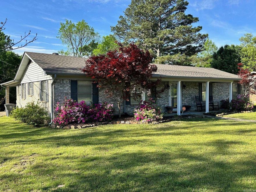 PRIME LOCATION in the heart of Hot Springs! Discover comfortable living in this well maintained, energy efficient brick home nestled on a spacious corner lot with nice curb appeal. The home backs up to woods making it a peaceful place to relax and where deer sightings are a delightful bonus. Step inside to find a smart layout that boasts a living room accented with a tile fireplace equipped with new gas logs and nice built ins for added convenience. The functional kitchen features newer appliances, a breakfast nook, and bar that opens to the inviting living space to keep you connected during gatherings. The separate dining room could double as your makeshift workspace for those days you can't make it to the office. Both bathrooms have been tastefully updated with new cabinets, granite countertops, and tile showers. The large laundry and mud room comes complete with a pantry and additional storage. The property is partially fenced and includes a shed and a storage closet off the carport. Additional updates include a Trane Commercial H&A installed in 2018, new roof 2024, and water heater 2021. For your convenience, the seller is also passing on the washer and dryer. Call today!