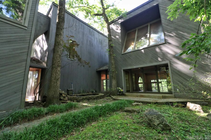 Step into this beautifully designed architectural gem. With just a few updates, this home will be everything you want and more. From the deck access in almost every room, to the above garage space, you will fall in love with the possibilities that this property could be. Plus with 25 acres of wooded land on which you can hunt, it's a perfect setting for wildlife as countless deer are seen daily! Come see it today!