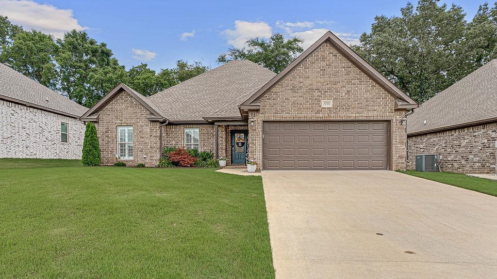 All brick and full of charm! This 4-bedroom beauty features a bright, open concept layout with a crisp white kitchen, granite island, stainless steel appliances, and dining area that flows perfectly for entertaining w/huge greatroom. The split floor plan offers privacy, with the laundry room conveniently located near the spacious primary suite. You'll love the spa-like bath with a soaking tub, tiled shower, and double vanities. Neutral tones throughout make it move-in ready for any style! Enjoy morning coffee on the screened patio overlooking the fenced backyard—perfect for pets, play, or a garden. Double garage, great layout, and all the right touches! Plantation shutters accent the windows and add a special touch.