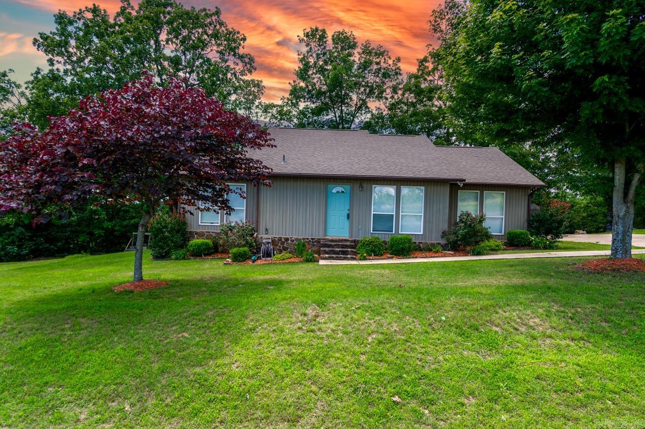 Enjoy year-round views of Greers Ferry Lake from this 3-bedroom, 1-bath home situated just ¾ mile from the boat launch and marina! Built in 2004, this 1,367 sqft traditional home sits on 1.25 acres and features a large back deck—the perfect spot for relaxing and taking in the scenery. Inside, the home offers tile flooring throughout the living areas, kitchen, and bathroom, with cozy carpeted bedrooms. The centrally located bathroom provides easy access from all bedrooms. The paved driveway offers plenty of parking, including space for a boat. Outside, beautiful landscaping with flowerbeds and ornamental trees adds charm to the property. A storage building conveys with the sale, providing extra space for lake gear and tools. Whether you're looking for a full-time residence or a weekend getaway, this home is a fantastic opportunity to enjoy lakeside living with convenience and comfort. Don't miss out—schedule your showing today!
