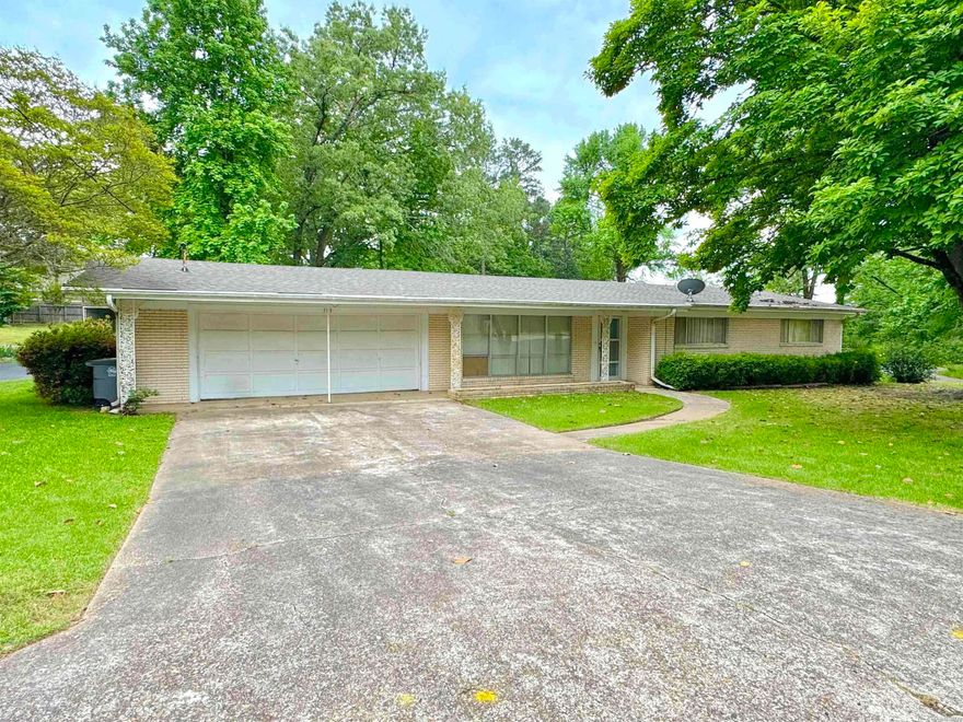 Great price on this 3 bedroom, 2 bath ranch-style home on Lakeland Drive in Hot Springs. Great location in town - close to everything!  Also very close to the lake and surrounded by beautiful homes. This is a one level home with no steps - the perfect fit for someone looking for easy living in a great neighborhood. Additional features include a new roof, primary bedroom with bath, walk in closet, walk in shower, spacious sunroom and a two car garage with lots of storage space.