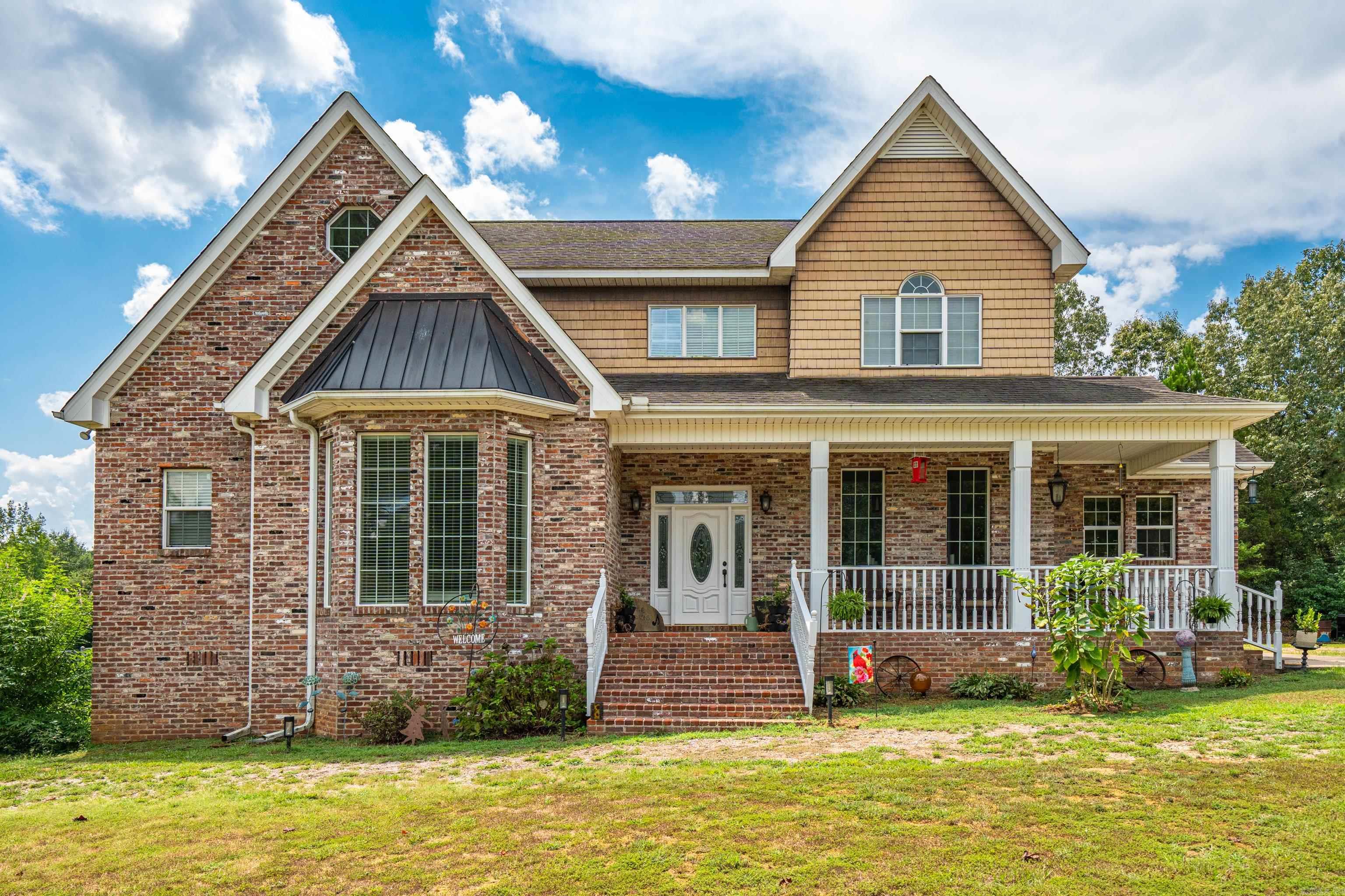 Welcome to country living! Nestled on almost 21 acres, this lovely 3-bedroom, 3.5 bath home offers comfort, charm and endless possibilities. Each bedroom includes a full walk-in closet, and the home features nine-foot ceilings, classic transoms above each door, hardwood floors, and a beautiful staircase. The brick is original, sourced from the historic Malvern Hardware Store, adding timeless character. Outdoor living is a highlight with a 34x20 deck, a screened-in 12x20 sunroom, and a large ex front porch for relaxing. The property also features a new 16x42 studio, currently set up as a music studio/craft room, with its own mini-split for heating & cooling. For those who love gardening, there's an expansive, fully fenced garden built with quality wood that's as attractive as it is functional. Additional features include a chicken coop with a run, a very nice hunting blind, a natural spring as well as a creek. The home is also all-electric and wired for a direct generator hookup. With open fields, wooded areas and versatile terrain, this property is ideal for a private retreat, hobby farm, or recreational use. Call to see this beauty today!