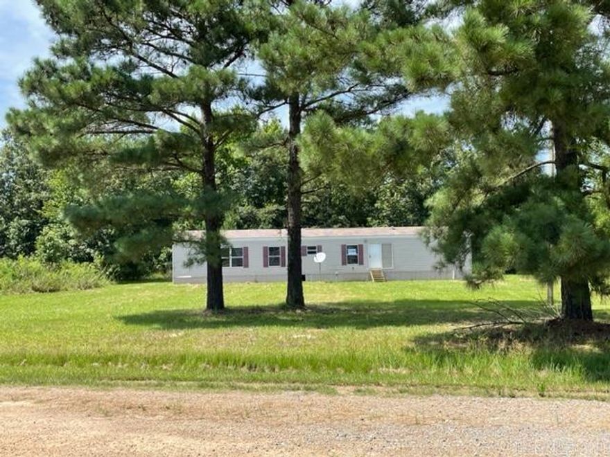 A single wide manufactured home set in a corner down a secluded street with a backdrop of woods on .83 acres.  A great rental property or starter home.