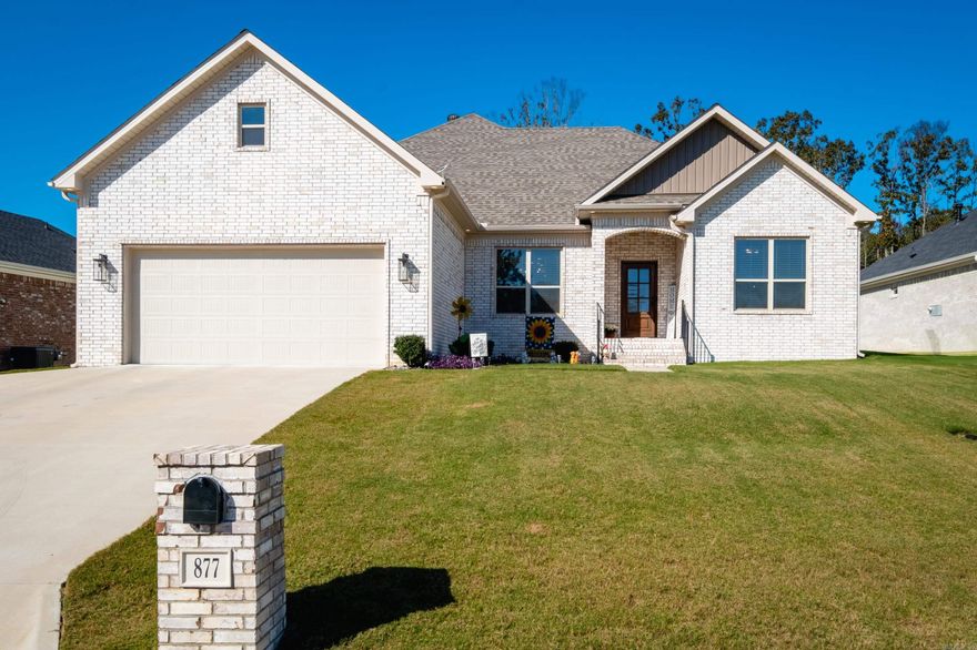 Immaculate 3 bedroom 2 1/2 bathroom home built in 2022 in the desirable Millers Glen subdivision! This meticulously maintained all-brick home offers an open layout perfect for entertaining. The spacious family room has a corner fireplace and is open to the eat-in kitchen and dining area. The chef’s kitchen features quartz countertops, an oversized island, custom cabinets, stainless appliances (gas cooktop, built-in microwave and oven) and a coffee bar. The private primary suite has a stunning spa-like bathroom with a soaking tub, custom tile shower, double vanity and a large walk-in closet that connects to the laundry room (including a sink and additional storage). On the other side of the home, there are two generously sized bedrooms and a hall bathroom with a shower/tub and double sinks. The backyard has a nice covered patio and is fully fenced. Additional features include: two-car garage + extra parking pad, half bath, custom blinds throughout, stairs leading to huge floored attic/unfinished space above garage, gorgeous molding, neutral finishes, no carpet, tons of natural light and more!