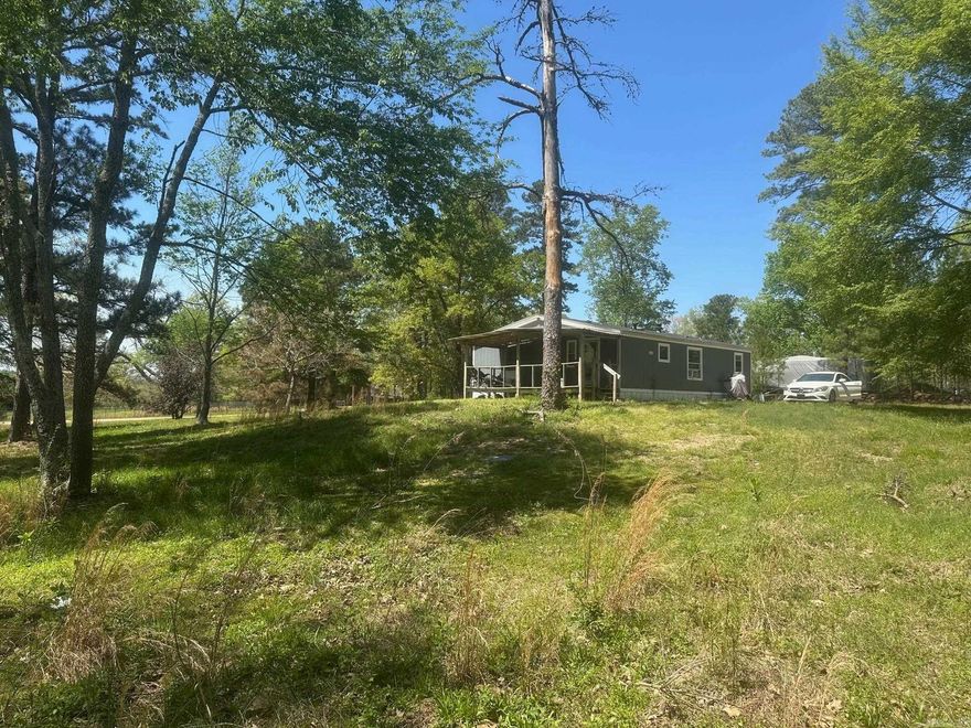 This home is located on 2.5 beautiful acres with lots of shade trees. Pole barn, with storage attached. City water. plus a well, Septic system. The floors in the home coverings (plank flooring) are incomplete.