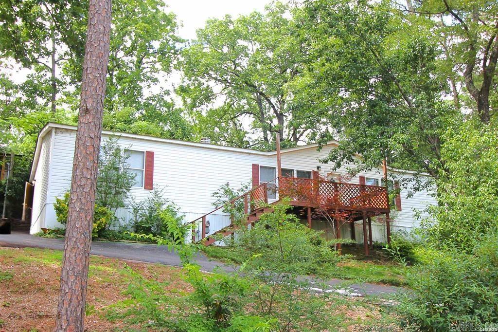 Sitting on a rise across from lake Hamilton, this manufactured home has a great view and nice landscaping with newly leveled blocking, lots of space and beautiful fireplace. It's ready for its new owner to call it home. Just a short drive from everything you need. Grocery store, great restaurants and shopping around the corner make this place convenient and a great place to call home or even turn it into income property!