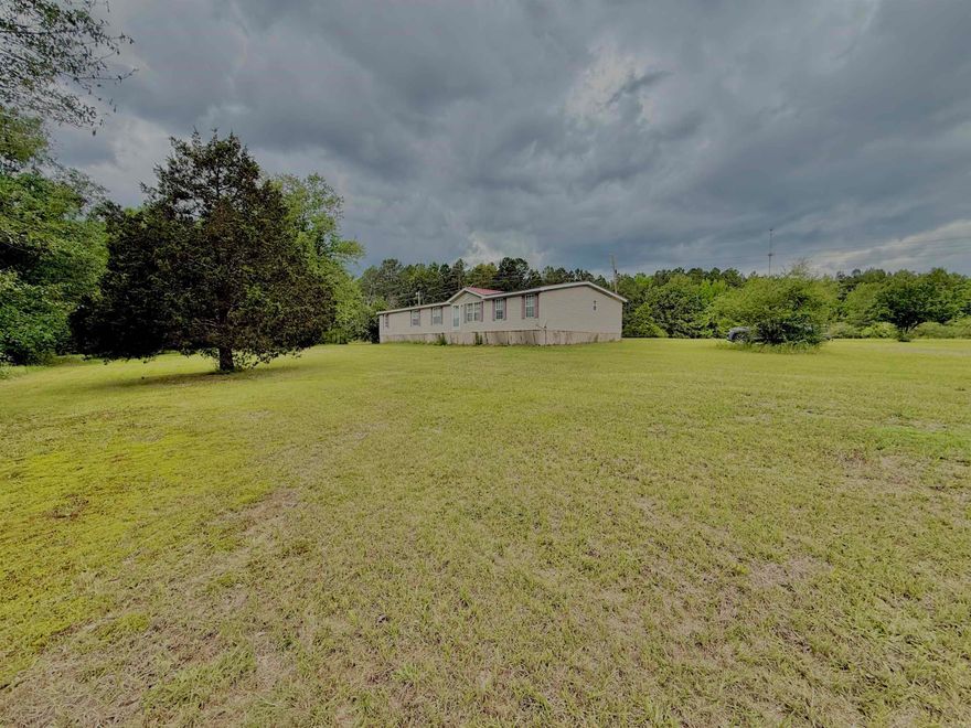 Fixer upper with room to grow! Sitting on 9.5 acres, this 2010 double wide offers space, potential, and the opportunity to create your dream homestead without breaking the budget. Featuring 5 bedrooms and 3 baths, this home has a spacious layout with an open dining and kitchen area, large living room, and generously sized bedrooms throughout. The primary suite includes a long walk-in closet and walk-in shower. Whether you’re looking to start a small farm, need room for animals, or simply want peaceful country living with space inside and out, this property is packed with possibilities!
