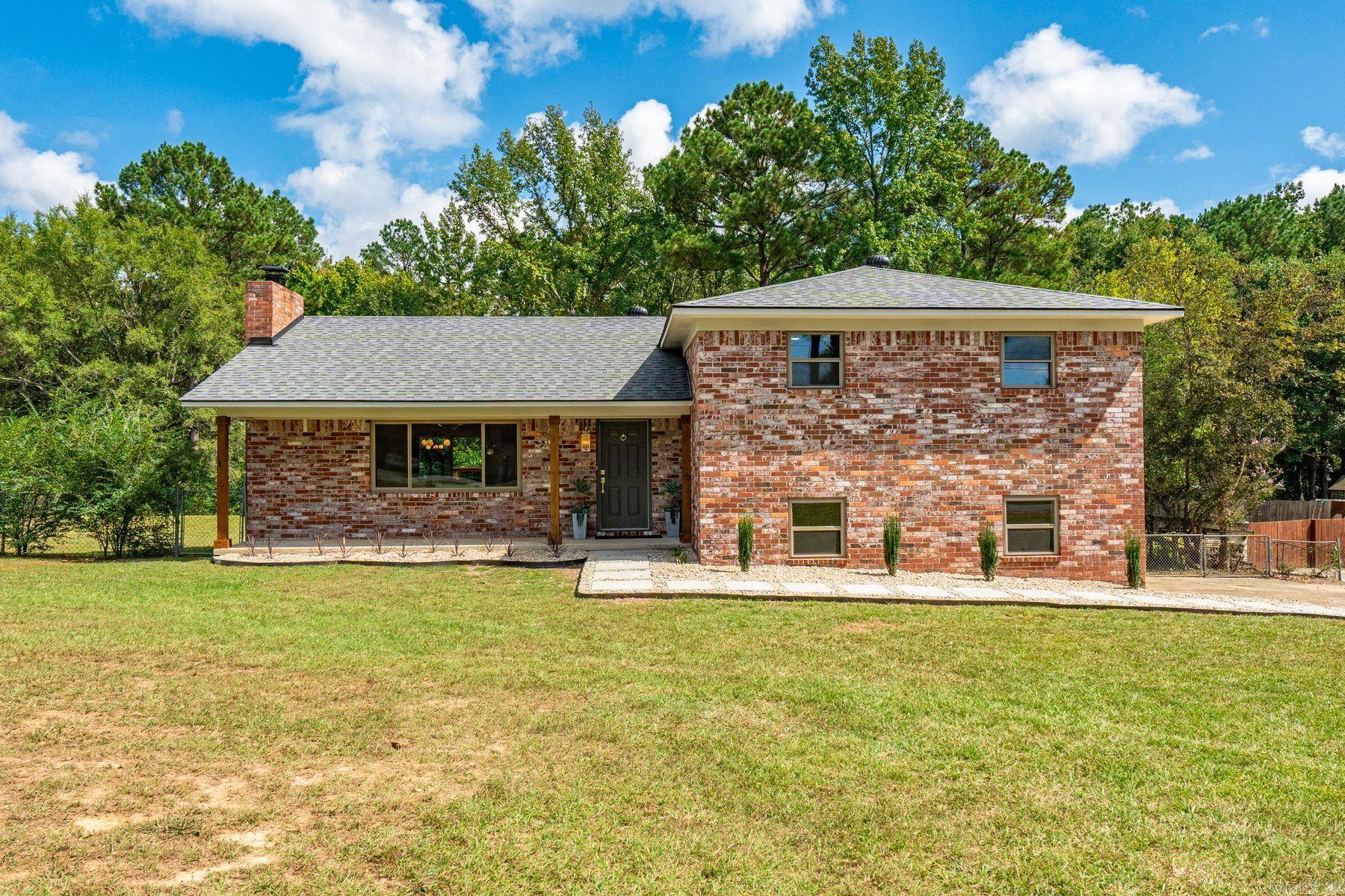 Situated at the end of a quiet, dead-end street, this beautifully renovated brick home offers a desirable open floor plan and modern aesthetic. A wood-burning fireplace clad in large-format tile creates a dramatic focal point for the living space. New cabinetry, quartz countertops, luxury vinyl plank flooring, custom tilework, and designer lighting carry the premium feel across the home. With 4 beds/3 full baths—including two private en-suites, ideal for guests, or multigenerational living. Major updates include a new roof, HVAC, water heater, appliances, and insulated windows, which provide lasting peace of mind. Outside, the generously sized level lot, oversized double garage, expansive new deck with sleek wire railing, and fully fenced backyard offer the perfect combination for play, pets, and gardening. The owners—who are also the listing agents—personally curated every finish, delivering a cohesive design that is both stylish and comfortable. (Bonus: This property sits outside the city limits and is not part of a subdivision, allowing you the freedom of living without POA fees or restrictions—whether that means a chicken coop, a shop, RV parking, you get to call the shots.)