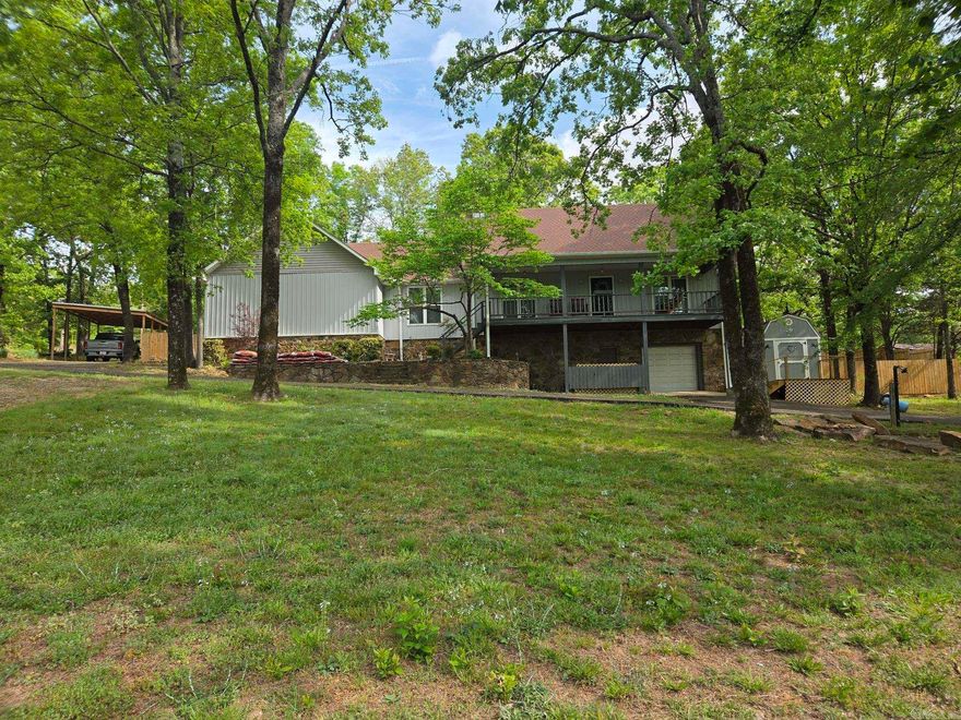 This well-built 2 story house just across the street from Searcy city limits also has a walk out basement. Many updates including vinyl windows, vinyl siding, cedar planks on deck, new wood privacy fence around the back yard & more. This 1.22-acre paradise has a top floor deck off the back & an elevated covered porch off the front to drink coffee & relax in the shaded view. Stone fireplace, 3 car garage, new gutters, separate laundry with sink, separate dining room, large living room with dual ceiling fans, main bath has a jacuzzi tub, lots of counter space & storage with walk-in closets. The basement has a heated & cooled 4th bedroom that could be used as a shop, storage, game room, office, etc. It has a 1/2 bath & new mini split & extra led lights in basement also. New paved driveway. See agent remarks.