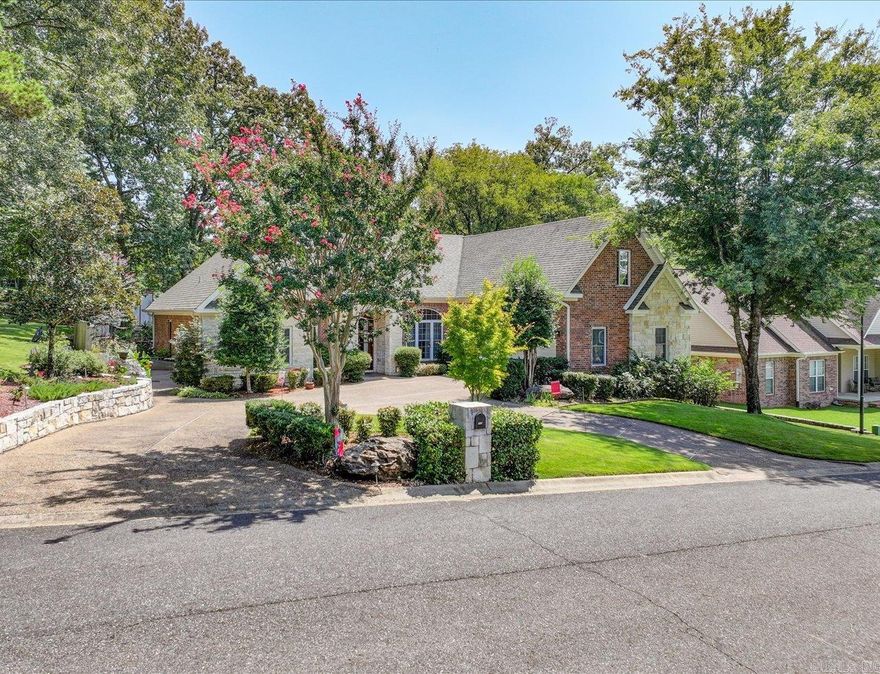 This home truly has it all: a prime location, stylish features, and exceptional amenities. Situated on a corner lot with a circular driveway and stunning landscaping, the natural limestone and red brick exterior showcase impressive curb appeal.   Inside, you'll find tall ceilings, an open floor plan, beautiful hardwood flooring, well-crafted crown moldings, and tall baseboards, complemented by crisp white trim. The layout promotes easy living and entertaining.  The impressive kitchen with custom cabinetry, granite countertops and decorator finishes, informal dining area, and family room flow together seamlessly, making it perfect for gatherings. Double French doors open up to the saltwater swimming pool and beautifully landscaped yard, creating an inviting outdoor space.  The oversized primary bedroom suite features an octagon-shaped tray ceiling, a spacious walk-in closet, and a large master bathroom with granite countertops and expansive tiled flooring.  A bonus room over the garage provides an excellent space for a game room, family playroom, or additional living area.  Outdoor living and entertaining are a breeze with the covered patio and adjoining swimming pool areas.