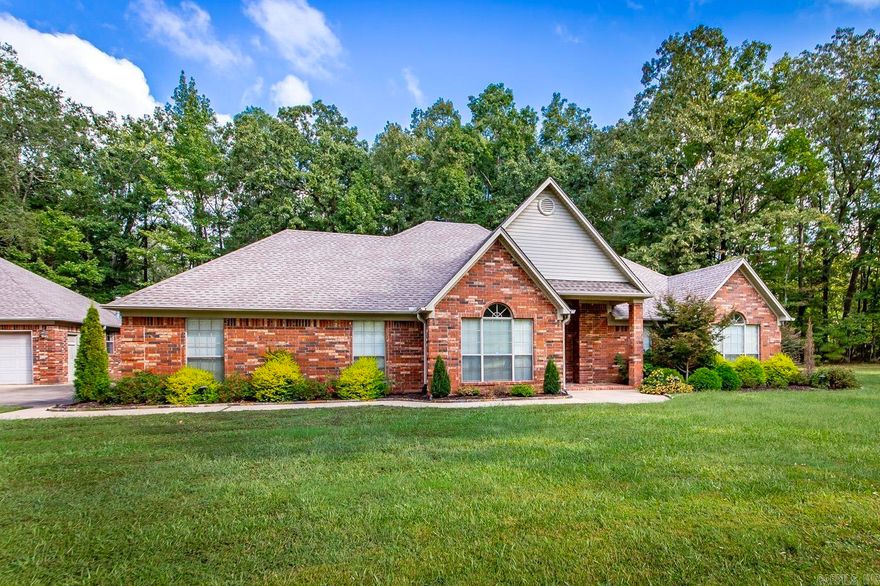 Welcome to 1560 Lawson Oaks Drive in Little Rock, a rare find on 10.63 acres in  Saline County. This property offers the perfect balance of privacy and convenience with wooded surroundings, a peaceful pond where deer often gather, and a quiet neighborhood feel. Built in 2000, the home features 4 bedrooms and 2 baths, including a formal dining room, a cozy den with a fireplace, and a bright kitchen designed for everyday living. The primary suite is a retreat with two walk-in closets, a spa-style bath with a huge soaking tub, dual vanities, and a separate shower. The attached two-car garage provides convenience, but the detached workshop truly sets this property apart—boasting three garage doors, its own half bath, and incredible workspace perfect for projects, hobbies, storage, or even a small business. Whether sipping coffee by the pond, hosting in the dining room, or working in the shop, this property delivers a lifestyle of comfort, nature, and freedom just minutes from Bryant schools, shopping, and dining. Feel free to measure sq.ft., it differs from tax records. measured by appraiser,  in MLS docs. Well System retention and pressure tanks/gauges replaced 2026.