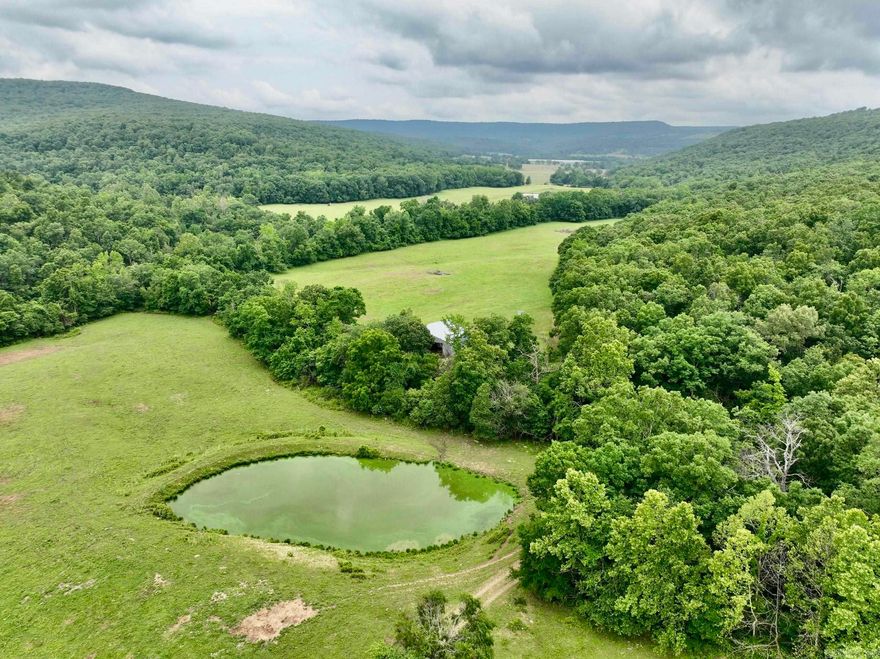 Welcome to the breathtaking cattle ranch located in the heart of the Ozarks. As you enter through the gated entrance and drive along the private road, you'll immediately notice the beauty surrounding you. The ranch boasts lush open bottom fields, perfect for cattle grazing and hay production, ensuring a thriving agricultural operation. The thoughtful design of this ranch includes two separate corrals with working pens, making livestock management a breeze. The entire property is fenced and cross-fenced, providing secure boundaries for your cattle. You'll find a well-built metal barn on the ranch, offering ample space for equipment and hay storage. With everything organized and protected, you can efficiently manage your ranching activities. One of the highlights of this property is Lollars Creek, meandering through the heart of the ranch. The tranquil sound of flowing water adds to the serene atmosphere. Additionally, multiple ponds are scattered throughout the property, offering an additional water source for livestock and creating picturesque views. The panoramic views from various points on the ranch are simply spectacular.
