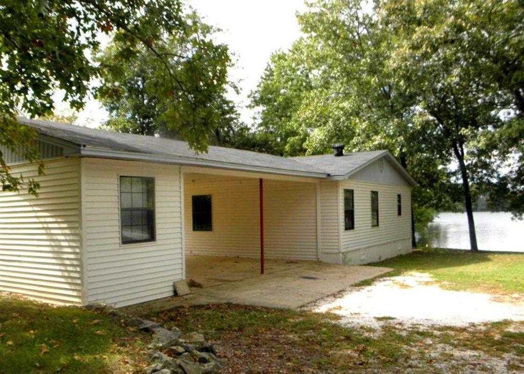 176' of Lake frontage for this 3/2 Lake cottage on the quiet North end of Lake Hamilton. Open floorplan for the living dining & kitchen. FP and great lake view off covered back deck. Mature trees on the property provide lush shade. This home is a double wide trailer that has been built and framed around.