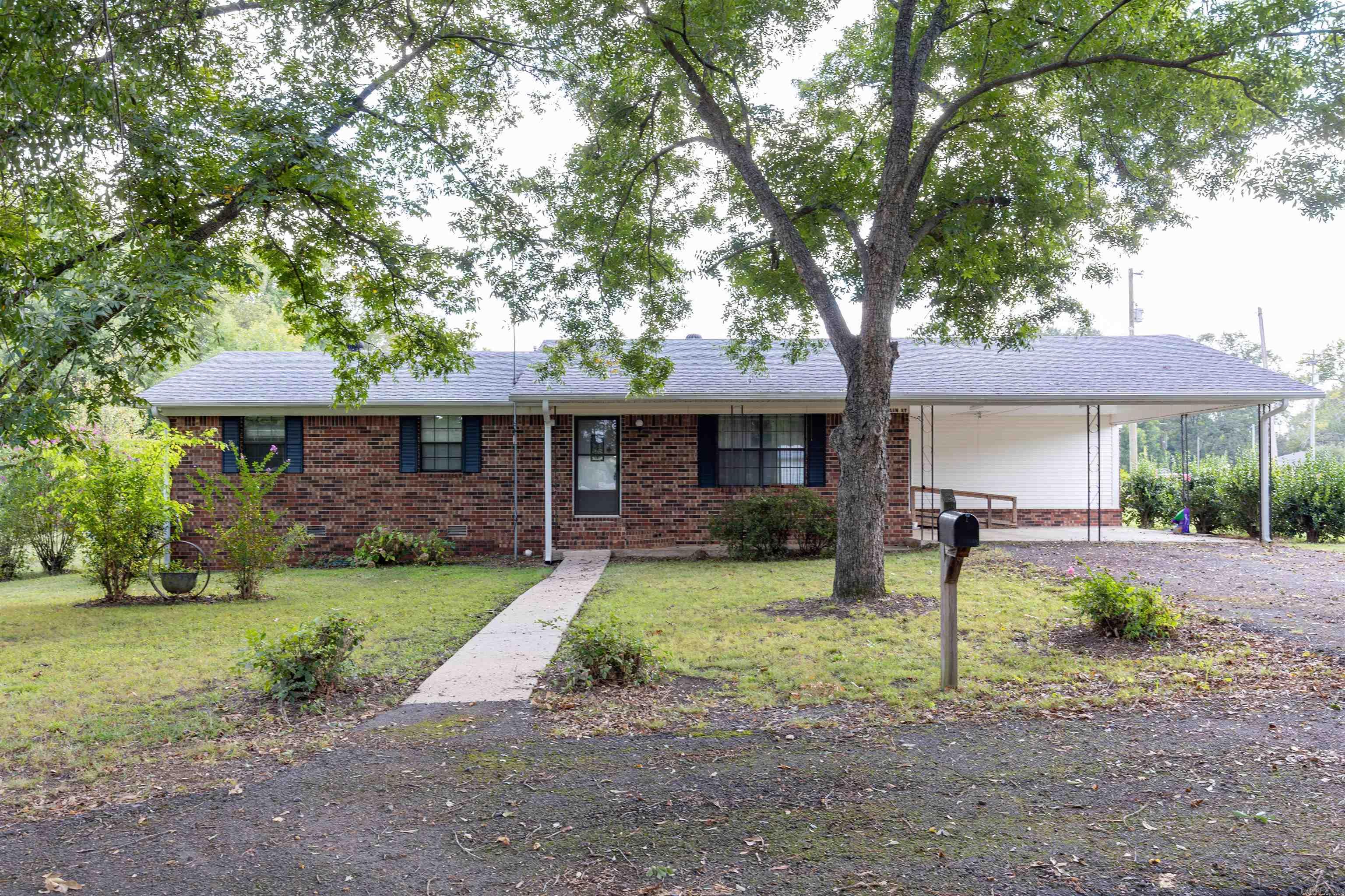 Pull down the circle drive into this well-maintained home on 2.64 city acres!! Properties like this don't come up very often. 3 bedrooms, 1.5 bathrooms and a nice sized shop! Hold onto the land for future value or sell separately! Lots of opportunities with this property. You could also purchase and turn into a commercial building! This home has a natural gas fireplace/heater. All closets are cedar lined. New flooring was put in the home this summer (2024). Roof was replaced in last few years. The refrigerator, washer and dryer will convey at no value with the home.