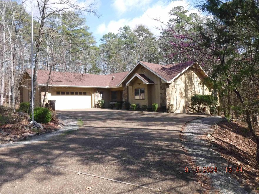 Fountain Lake home on the east end of Hot Springs Village. East gate offers easy access to Benton/LR or Hot Springs. Come check out this one level home with concrete under house storage. Large deck and very pretty outside space. Living room/kitchen/dining room have an open concept. Two car garage. Good size 2nd bedroom. Large "family" closet in the hallway offers TONS of extra storage. Large master suite with double doors to the back deck. Double closets. Master bathroom has a walk in shower and big jetted tub. Large Arkansas room on back of home is full of windows and offers a great view to the woods behind. With a little TLC and updating this home could be a show piece.