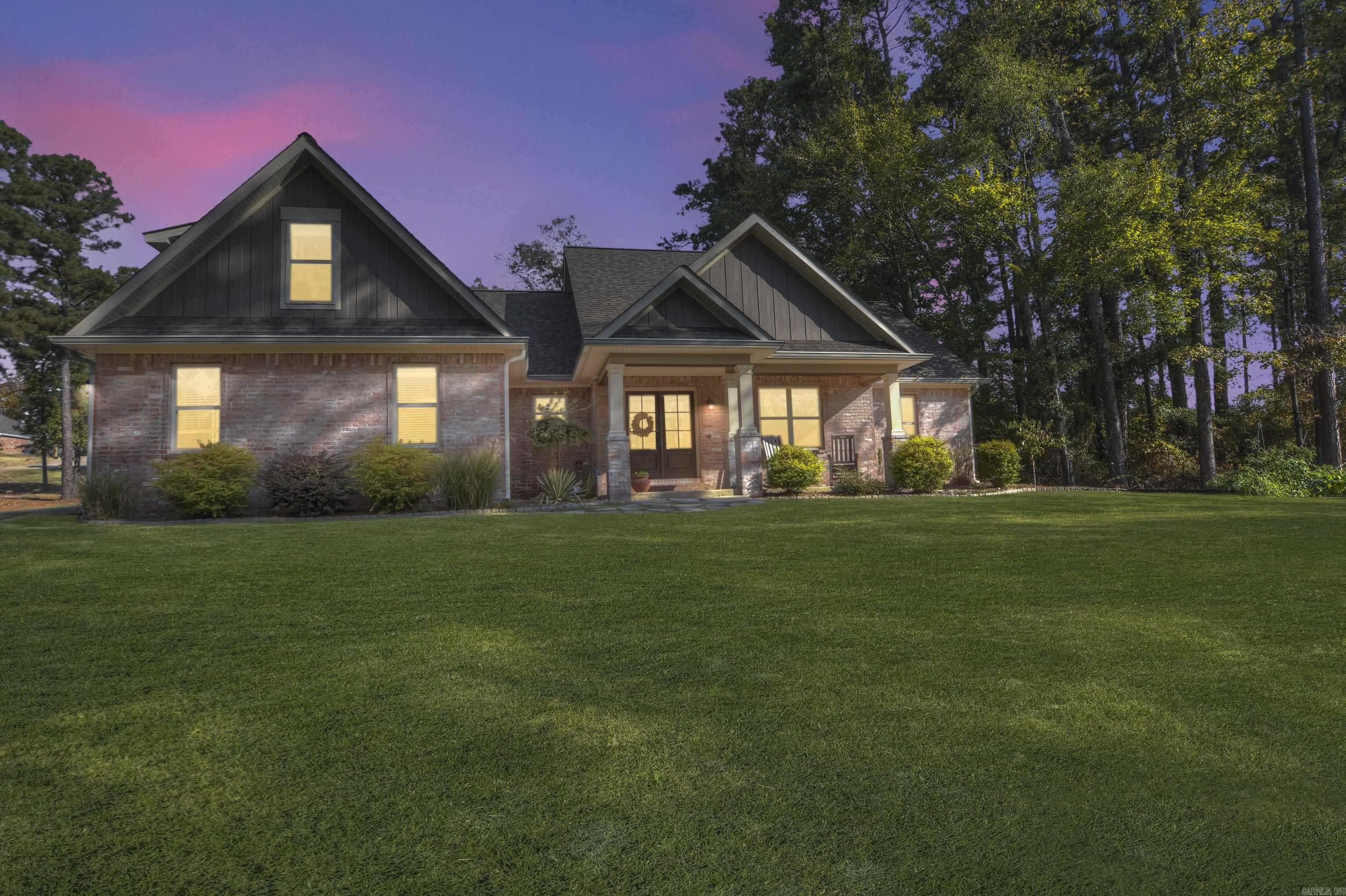 This charming 1½ story Craftsman-style brick home sits on a 0.63-acre lot just minutes from Garvan Gardens and Entergy Park. Featuring beautiful hardwood floors throughout, a vaulted ceiling and fireplace in the family room, and a luxurious primary suite with tray ceiling and en suite bath, this home blends comfort and style. With two additional bedrooms on the main floor, and a fourth bedroom upstairs that can serve as a guest suite or game room, there’s plenty of space. Outdoors, enjoy a covered patio, a custom playground in the fenced backyard, and an oversized two-car garage. Recent updates include a new roof, gutter guards, and steel insulated doors (2023). Perfectly maintained, this home offers modern style and a fantastic location. Don't miss this opportunity!