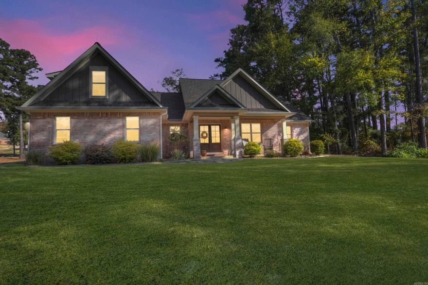 This charming 1½ story Craftsman-style brick home sits on a 0.63-acre lot just minutes from Garvan Gardens and Entergy Park. Featuring beautiful hardwood floors throughout, a vaulted ceiling and fireplace in the family room, and a luxurious primary suite with tray ceiling and en suite bath, this home blends comfort and style.  With two additional bedrooms on the main floor, and a fourth bedroom upstairs that can serve as a guest suite or game room, there’s plenty of space. Outdoors, enjoy a covered patio, a custom playground in the fenced backyard, and an oversized two-car garage.  Recent updates include a new roof, gutter guards, and steel insulated doors (2023). Perfectly maintained, this home offers modern style and a fantastic location. Don't miss this opportunity!