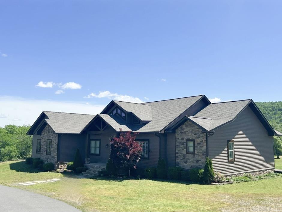 This exquisite 5-bedroom, 3.5-bathroom home, custom-built in 2017 by Pat Usdrowski, offers luxurious and functional living spaces on 2 acres +/-. Enter through a grand entryway into a stunning living room with high ceilings, wooden beams, and custom built-ins surrounding a floor-to-ceiling stone gas log fireplace. The chef’s kitchen features a walk-in pantry, stainless steel appliances, granite countertops, a stone tile backsplash, and a spacious island. The front room is versatile, suitable as a formal dining area or playroom, and an office is conveniently located nearby. The laundry room boasts a counter, sink, and hall tree storage. The master bedroom has a tray ceiling and doors leading to the back deck. The master bath includes a granite double vanity, walk-in closet, and slate shower with double showerheads. Upstairs, find two guest bedrooms sharing a Jack-and-Jill bathroom. The downstairs area includes a living room with a projector, a bar kitchen area, two bedrooms, a bathroom, a gym bonus room, and an 882 sq. ft. bonus room. New roof April 2025! Located in the Lakeside School District, this home combines modern amenities with a tranquil setting. Appraisal on file.