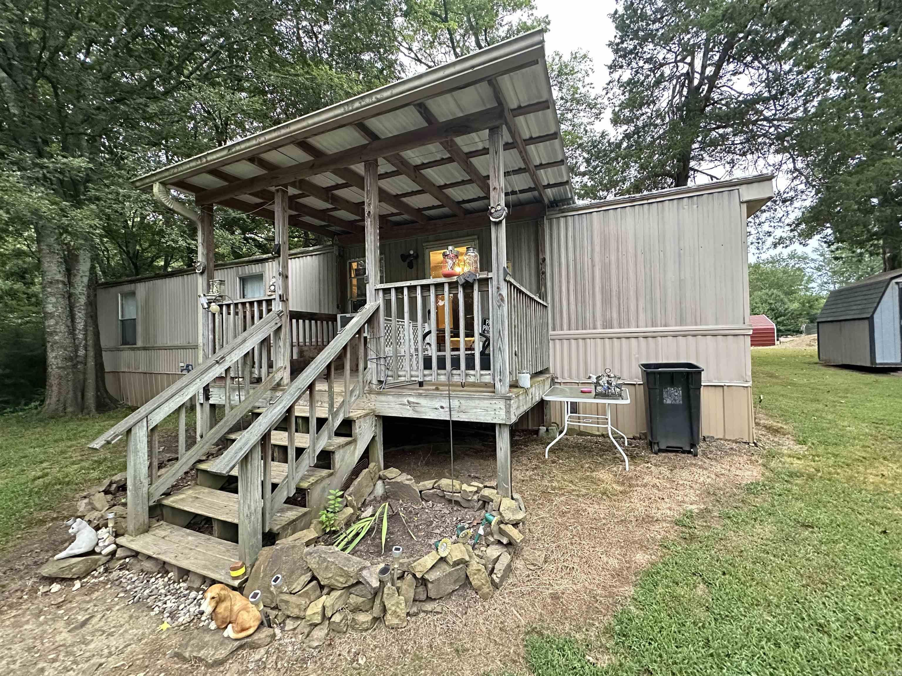 Tucked away on nearly an acre on Sunny Gap Road, this charming 2-bedroom, 1-bath mobile home offers privacy and peaceful country living. Enjoy quiet evenings on the covered front porch, with no neighbors in sight from the road. The open floor plan makes the home feel spacious and inviting. Additional features include a newer concrete storm cellar, a storage building, and a newer refrigerator that conveys with the property. Perfect for those looking for a quiet retreat with room to spread out! Priced accordingly for an as is sale!