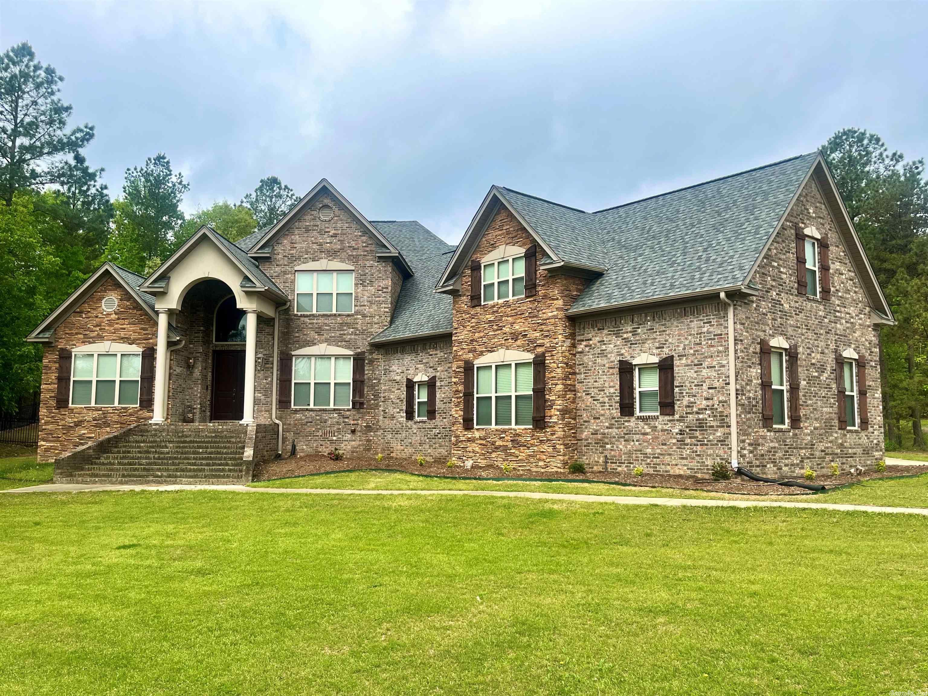 Welcome home to 7011 Gemstone! This exquisite home is located in highly sought after Stonehill Estates.  The expansive floor plan has an immense amount of natural lighting and storage. A large family room has a beautiful gas fireplace and tons of built-ins with a wall of windows overlooking the backyard oasis. Stunning granite countertops, stainless appliances, double oven, under counter ice maker, and gas range all compliment the beautiful chef's kitchen. Split downstairs floor plan with Master bedroom and separate in-law suite are perfect for peace and privacy.. Upstairs offers a huge bonus room along with 3 bedrooms and 3 bathrooms! A fully fenced back yard with covered porch and woodburning fireplace overlook the luxurious saltwater pool. This home is an absolute dream for anyone who loves to entertain and enjoys watching wildlife right out their window. Storm shelter, tankless hot water, gutters, and a brand new roof in 2022 are several of this homes fabulous extras. You must see! See agent remarks.