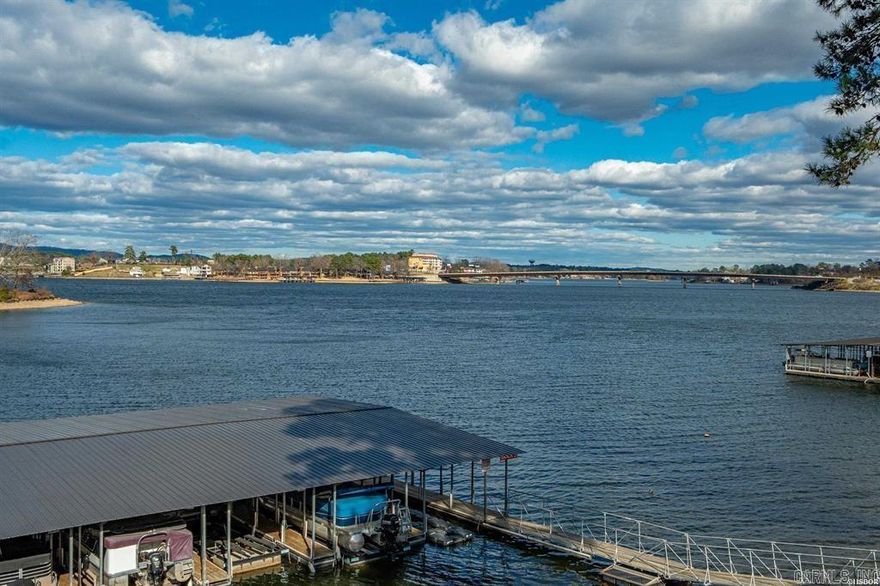 Move in Ready and Fully Furnished! Welcome home to this beautiful 2-bedroom, 2-bath condominium offering stunning views of Lake Hamilton in a peaceful, private, and conveniently located setting. Situated within a secure, gated community, this property offers the perfect balance of relaxation and recreation. Residents enjoy resort-style amenities including tennis courts, a swimming pool, and a hot tub—ideal for weekend getaways or entertaining guests. The open-concept floor plan is designed for comfort and functionality, featuring abundant natural light and serene lake views throughout the living space. Whether you are seeking a full-time residence, a vacation retreat, or an investment opportunity, this rental-friendly community provides exceptional versatility and value.