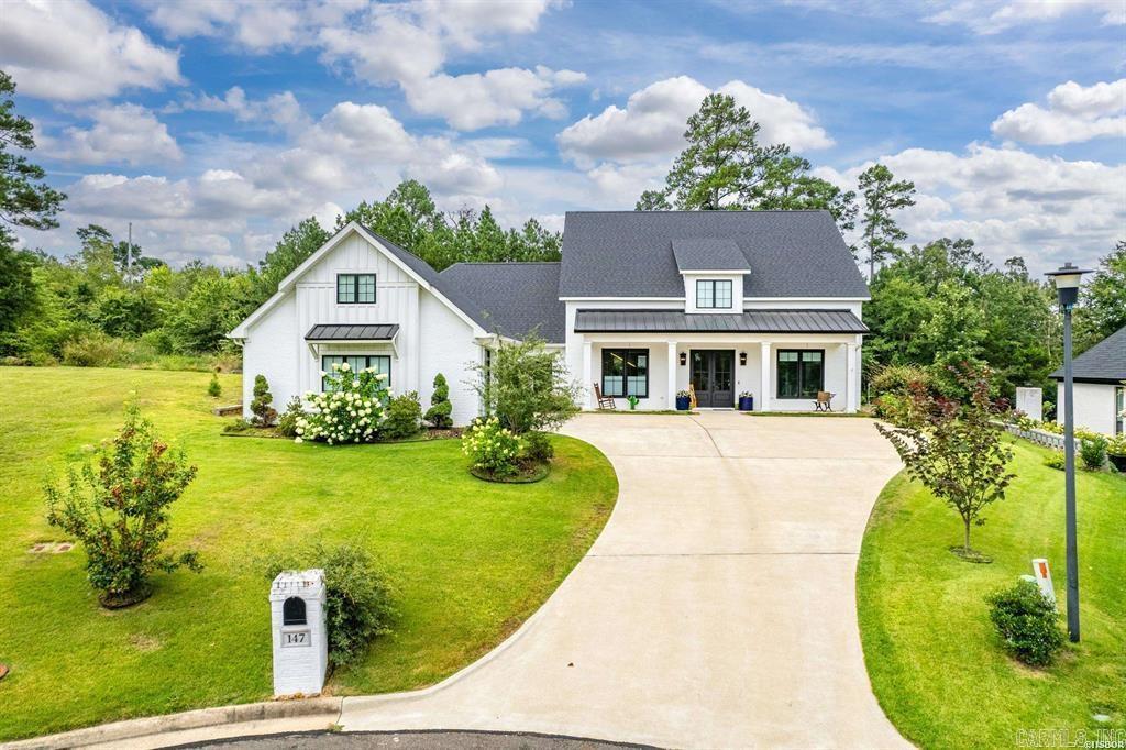 A stunning custom built home that offers a warm and welcoming feel throughout the home with large windows and natural light. From the minute you enter the home, you are met with quality throughout. Custom features include extra wide hallways, a large walk-in pantry that combines both kitchen storage and a functional workspace area for your office equipment/printer; special kitchen features such as a drawer for your spices; a drawer to hold your kitchen spatulas and accessories. A well-designed mudroom with built-in cubbies serves as both a functional entryway from the garage and a stylish transition space from the outdoors to the indoors. The primary suite is thoughtfully designed with an adjoining bath, incorporating a well-planned layout where the closet is conveniently located off the bath, and the laundry room is tucked away adjacent to the closet. Off of the living area are 2 additional bedrooms with a jack and jill bathroom. Imagine stepping out onto a back patio that feels like a cozy extension of your home with an outdoor fireplace that offers warmth on cooler evenings. The home sits at the end of a cul-de-sac with woods behind for privacy as you enjoy the back patio.