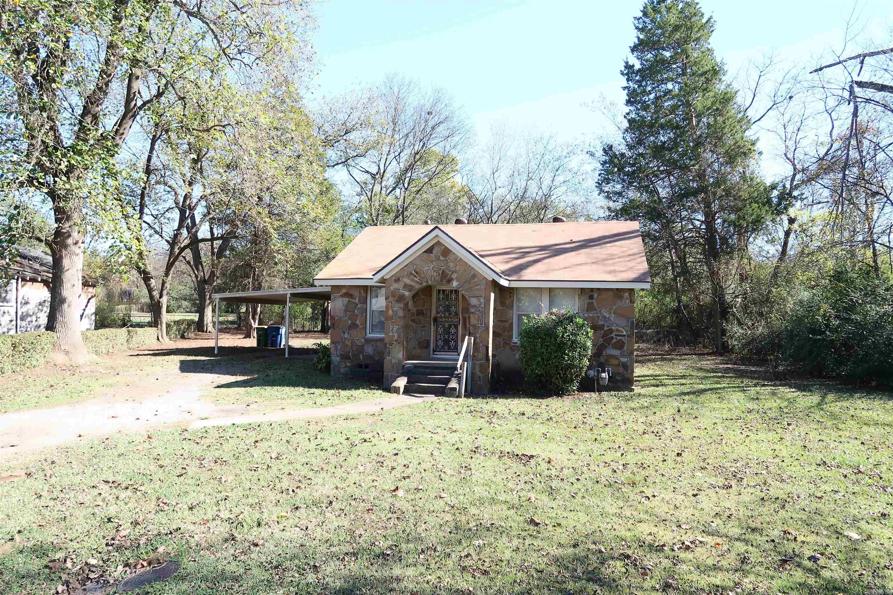 Amazing Opportunity!!!...Beautiful Rock Home with two bedrooms and one bath, with two Living Areas......one of living areas is Huge with LVT and also large size Laundry room . Lets talk about the LOT....... Huge @ .76 of an acre......Fully Fenced ... partially wooded. The fenced (all .76 acres) /gated backyard is perfect for a Family pet... You will also find a two cr covered carport.......with plenty of room on the side to park additional car or boats... NEW ROOF -Aug 23, HWH-1 yr old