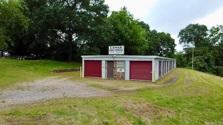 $1,250 in monthly rental income at full occupancy!  Income-producing 28-unit mini storage complex with excellent visibility, located directly on US Hwy 64 in Lamar, AR. This well-maintained facility includes twelve 10x15 units, ten 10x10 units, five 10x20 units, and one office space. The property is in great condition and features a prominent roof sign for added exposure, along with an electric meter servicing both lighting and the office. With a low-maintenance design and high-traffic frontage, this is a strong investment opportunity in a growing area.  Current rents are below market with the opportunity to increase rent and cash flow!