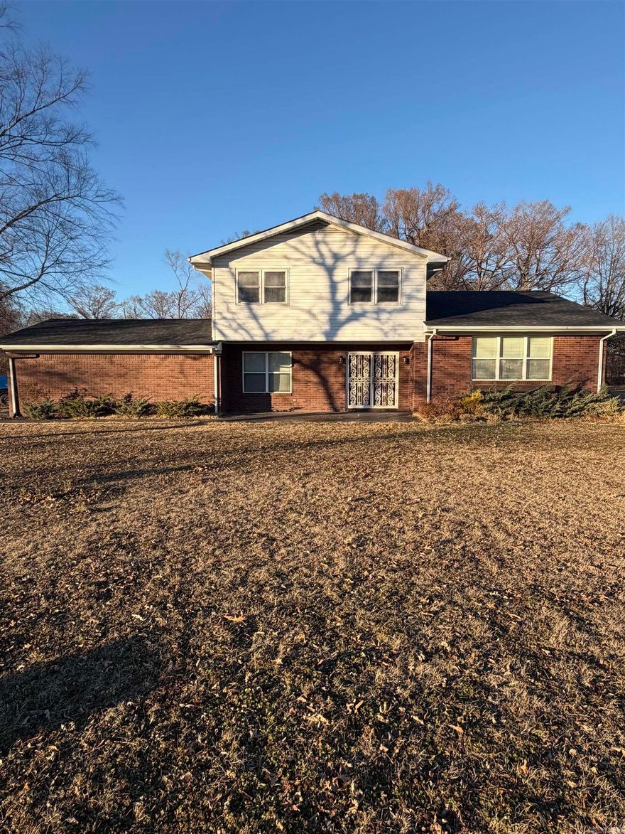 Enjoy peaceful living on nearly one acre at the edge of town in this spacious 2,700 sq. ft. home featuring 5 bedrooms and 3 bathrooms. The open-concept living, dining, and kitchen area was remodeled in 2019–2020 and includes LVP flooring, updated cabinetry, countertops, and stainless steel appliances. The inviting living room offers a propane fireplace, while a large den provides additional space for a second living area or game room. Major updates include a roof and HVAC system installed around 2020, along with a 22KW Generac whole-house generator. The primary suite features two closets and access to a bonus room that can serve as a playroom or fifth bedroom. Multiple bathrooms have been remodeled for added comfort and functionality. Additional features include city water, Clay County Connect internet, gutters, and a French drain system. This well-maintained home offers space, updates, and a convenient location just outside city limits.
