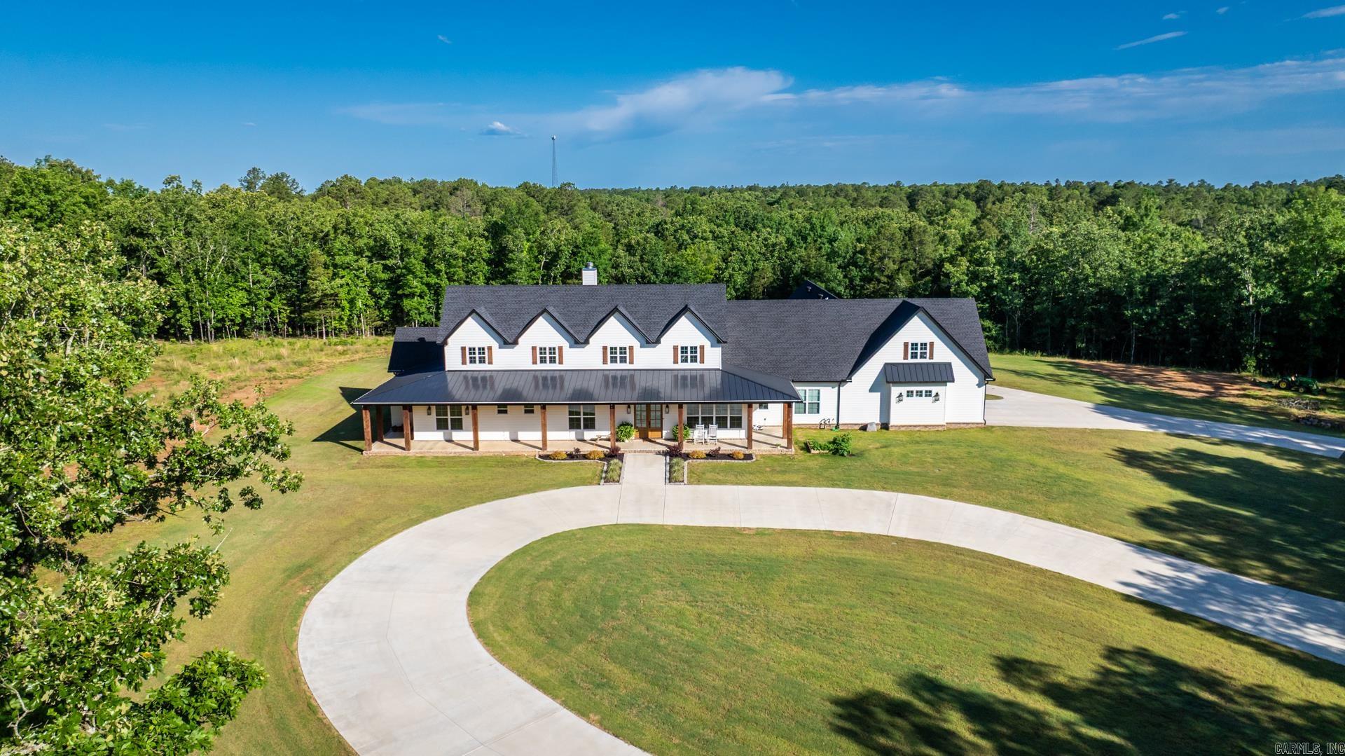 The MOST BEAUTIFUL home ever, WOW they thought of EVERYTHING in this custom build! Elegance, privacy, and functionality all in this 5-bedroom, 5.5-bath estate, nestled on 40 wooded acres. A private sanctuary just minutes from town connected to THE CRESTHAVEN neighborhood, with expansive living spaces featuring a wood-burning fireplace, soaring ceilings, and a seamless flow perfect for both everyday living and grand entertaining. The gourmet kitchen is A CHEF'S DREAM, complete with a spacious butler’s pantry, premium appliances, and an oversized island. Two dedicated home offices provide ample space for work or study. Retreat to the luxurious primary suite, featuring a spa-inspired bath and tranquil views. Each additional bedroom includes an en-suite bath, ensuring comfort and privacy for family and guests alike. Step outside to a resort-style oasis: a gunite saltwater pool with a tanning ledge, integrated hot tub, and breathtaking views of the surrounding land. Entertain effortlessly with a large covered back porch, full outdoor kitchen, and separate screened-in porch—ideal for year-round enjoyment. Additional features include a home gym, large safe room, and pond.