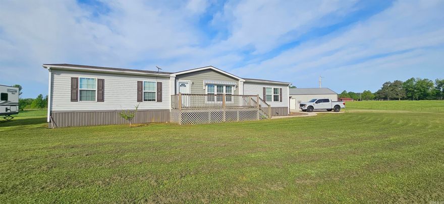 MOTIVATED SELLER! Seller willing to give a significant credit toward closing costs. Nestled in the foothills of the Ouachita Mountains, this 14.09 +/- acre property offers fenced & partially cross-fenced pastureland with endless potential. The 4BR/2BA manufactured home features an open-concept layout with split floor plan, spacious primary suite with 3 closets, soaking tub, walk-in shower, & abundant storage. Kitchen offers ample cabinetry, workspace, & separate pantry.  Outdoor improvements include a 30x30 shop with electric plus a 12x15 interior room ideal for storage, hobbies, workspace, or gym area. Acreage has been utilized for hay production in recent years & also includes a fenced 100x100 garden area. Additional custom-built 16x48 tiny home available separately or may be negotiated with sale. Features include metal roof, upgraded insulation, spray foam insulation underneath, tongue-and-groove interior finishes, LVP flooring, & tiled walk-in shower. Conveniently located near outdoor recreation areas, lakes, rivers, & national forest land.