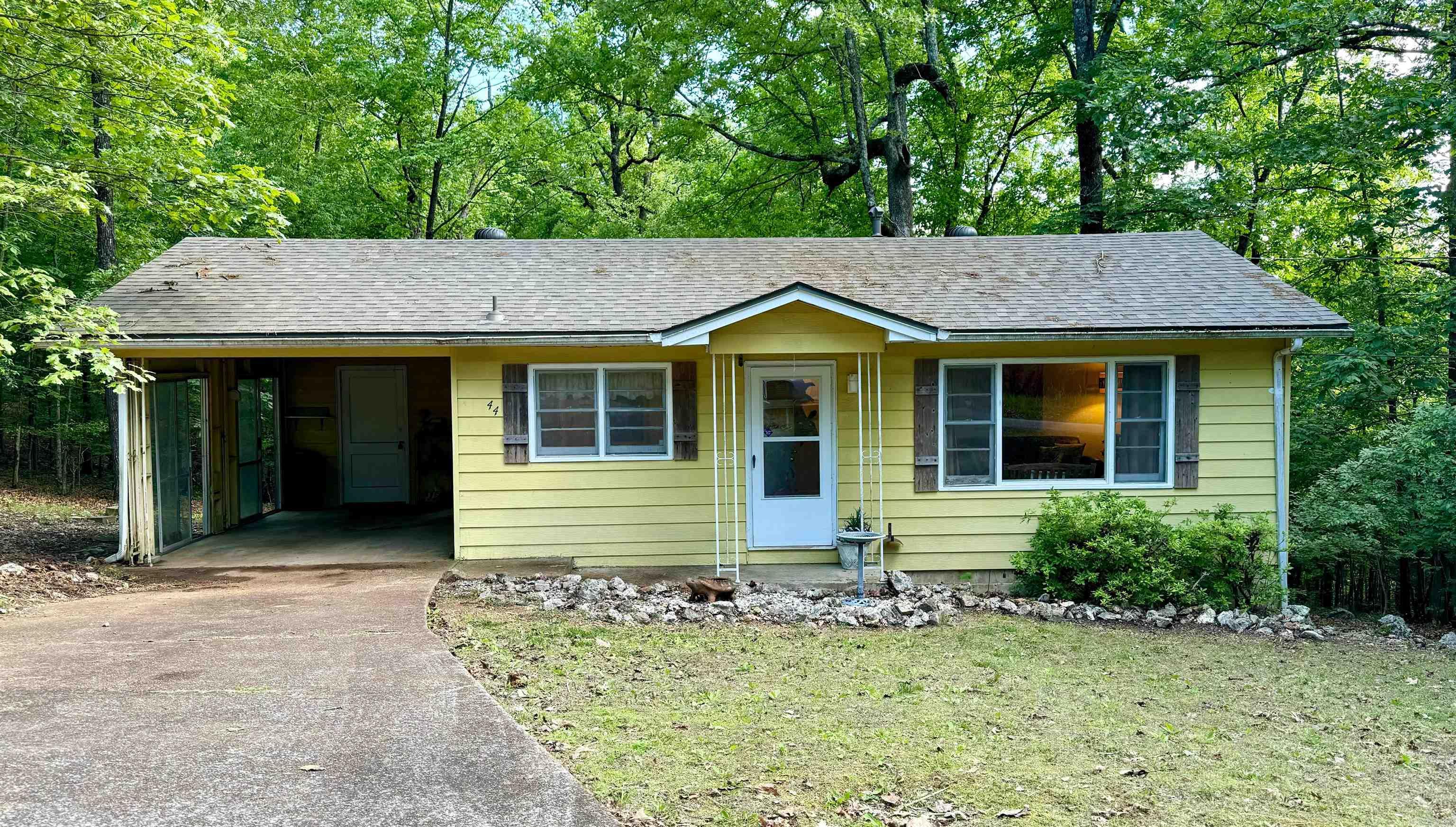 A super cute home in Cherokee Village sits on a private lot just a short distance from Lake Sequoyah. The home has 2 bedrooms and 1 nice bathroom. It features a spacious living room with a lovely picture window. The cute cottage-style kitchen is perfect for any cook and includes all appliances. The roof is one year old. The storage room off the carport is plumbed for a washer/dryer hookup. All furniture and most of the home decor accessories can remain with the home. The front yard is level, and the back yard has a gentle slope away from the home, offering a view that can be enjoyed from the deck. The home also offers additional storage space underneath in a walk-in crawl space. This home is easy to show.