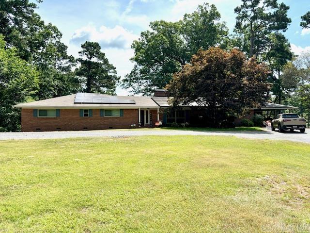 Discover your dream home with this newly remodeled 4BR/2.5BA brick house, sat on 3.5 acres. Inside you will find wood floors that flow seamlessly through the entry, den and hallway. The remodeled kitchen, boasts granite counter-tops, new tile back-splash & impressive stainless steel appliances. Enjoy abundant cabinet storage and new LED lighting/ceiling fans throughout. The house has new windows, and has been freshly painted (excluding kitchen & primary BA). The primary suite features a generous walk-in closet and luxurious bathroom with walk-in shower and soaking tub. The finished basement is 1,900 sq. ft. with 1BR/1BA, game room, office, hobby room, laundry room, and more. The outside features Plantation Shutters, double carport, and a box car the owner has converted to an office space; finished with central heating/cooling, sheet rock, vinyl plank flooring, and its own generator. The home comes with a solar panel system and Tesla batteries that provide energy efficiency, reducing your utility costs, and also can act as a home generator. Seller intends to pay off solar panel system, with transferable 30-year warranty, along with warranty backed Tesla batteries, and windows.