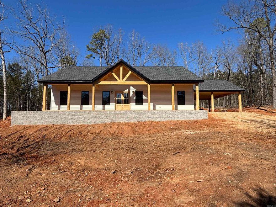 Welcome Home to this beautiful new home offering timeless charm and modern finishes! Open concept layout filled with natural light, high quality craftmanship, and stylish details throughout. The inviting living space flows seamlessly into the kitchen and dining area. Granite countertops and dedicated pantry for the kitchen, along with an island for extra space and great for entertaining! Double attached carport and stunning covered porch on front and back of home, perfect for relaxing in the beautiful natural surroundings. This home sets on 5 wooded acres +/- with the option to purchase additional acres. Survey to be provided at closing. Agent has ownership interest