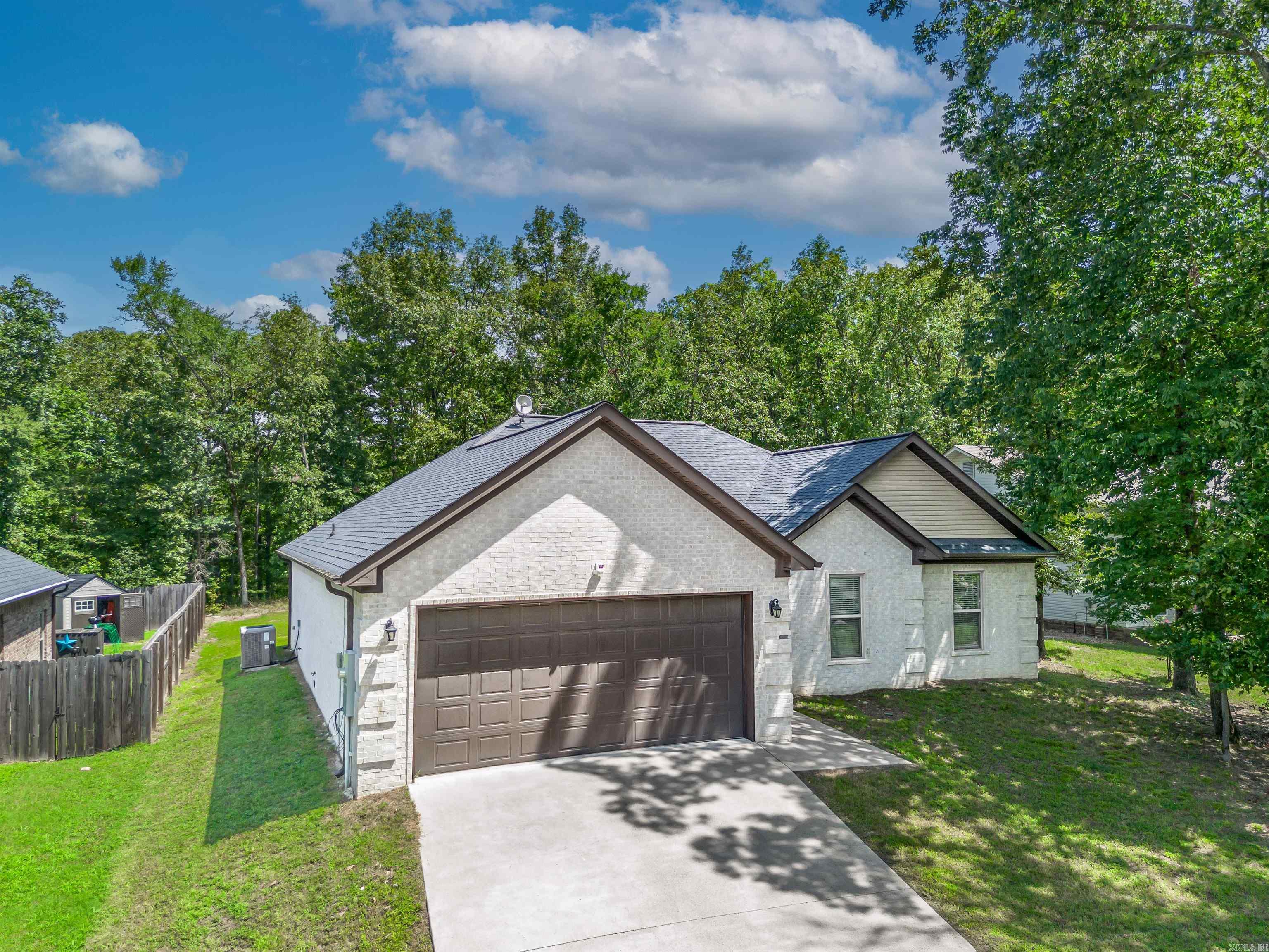 Nestled in the gated Diamondhead community, this beautifully maintained single-level brick home offers 3 bedrooms, 2.5 baths, and a thoughtful open-concept layout. Built in 2019, the home features LVP flooring throughout, a cozy fireplace, and a seamless flow from the spacious living area into a modern kitchen equipped with stainless steel appliances, a breakfast bar, pantry, and ample counter space. French doors lead to a covered patio with its own outdoor fireplace and TV hookupāperfect for relaxing or entertaining. The private primary suite includes a luxurious bath with dual vanities, a soaking tub, a walk-in shower, and a generous walk-in closet. Two additional bedrooms share a full guest bath, while a half-bath offers added convenience. The backyard, gentle slope, and mature landscaping provide low-maintenance outdoor enjoyment. Enjoy the many perks of Diamondhead, including a swimming pool, tennis courts, playground, clubhouse, and nearby lake access. With a two-car garage, energy-efficient features, and a low monthly HOA, this home is ideal for families, retirees, or anyone looking for comfort, convenience, and amenities all in one place. Agents see Remarks*