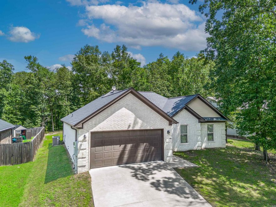 Nestled in the gated Diamondhead community, this beautifully maintained single-level brick home offers 3 bedrooms, 2.5 baths, and a thoughtful open-concept layout. Built in 2019, the home features LVP flooring throughout, a cozy fireplace, and a seamless flow from the spacious living area into a modern kitchen equipped with stainless steel appliances, a breakfast bar, pantry, and ample counter space. French doors lead to a covered patio with its own outdoor fireplace and TV hookup—perfect for relaxing or entertaining. The private primary suite includes a luxurious bath with dual vanities, a soaking tub, a walk-in shower, and a generous walk-in closet. Two additional bedrooms share a full guest bath, while a half-bath offers added convenience. The backyard, gentle slope, and mature landscaping provide low-maintenance outdoor enjoyment. Enjoy the many perks of Diamondhead, including a swimming pool, tennis  courts, playground, clubhouse, and nearby lake access. With a two-car garage, energy-efficient features, and a low monthly HOA, this home is ideal for families, retirees, or anyone looking for comfort, convenience, and amenities all in one place. Agents see Remarks*