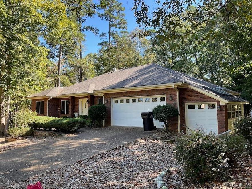 This place is a special retreat.  It has a large back yard with pathways, rock gardens and an extra lot for additional space.  Inside enjoy a cozy fireplace in the living room with vaulted ceilings that is open to breakfast room and kitchen. There is also a sizable dining room. The office has builtins and windows for natural lighting. The kitchen comes with high end appliances and pantry. Split bedrooms. Guests will enjoy two bedrooms and bath and one of the guest bedrooms opens to the newly refinished deck. Spend quiet time in the enclosed Arkansas room, then take a few steps down to relax in the hot tub.  The owner's suite also opens to the Arkansas Room.  Owners bath has separate shower and jetted tub and a long vanity with two sinks.  Bathroom also has large linen closet and separate walk-in closet.  2 Car garage with extra storage and golf cart garage.