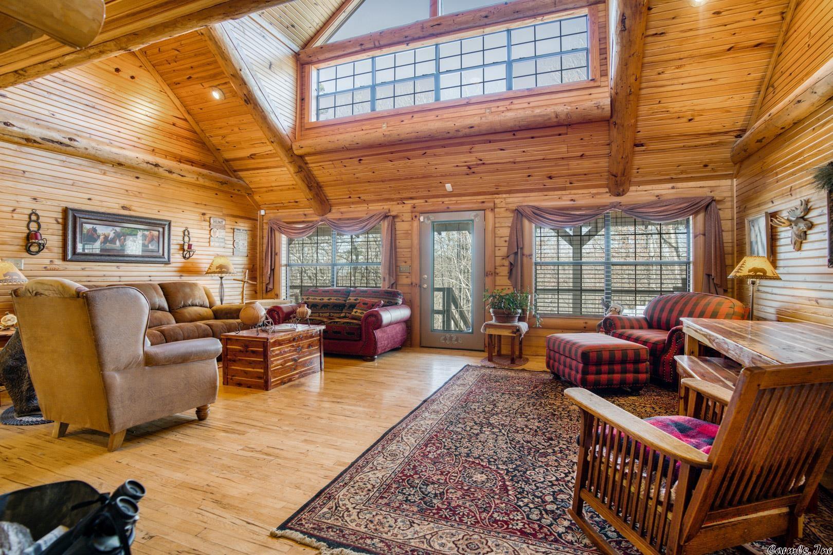 Incredible Custom Built Log Home sitting on 15.05 acres (surveyed) at the end of secluded road in Marshall. 3,000+ square feet, 4 bedrooms + Bunk Room, 3 Full Baths, 2 Car Garage that is extra deep, spacious rooms, tons of windows, covered front and back porch, walk out basement. Gorgeous Hand picked White & Brown Hickory Floors throughout. Metal Roof + Gutters. Brand new 24X44 Horse Barn! This home is built on a slight incline from front to rear with a wooded hillside setting where you can watch wildlife and/or your horses. 15 minutes to the Buffalo River!!! This is a gated property and can be shown by appointment only. Schedule your showing today!!!