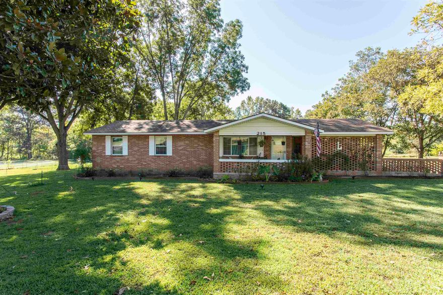 All-Brick NEW Renovated Home with Detached Garage, Vineyard & Creek Access  Located at 215 W Main Street, Evening Shade, AR, this 1,500 sq ft all-brick home has been fully renovated down to the studs. Updates include spray foam insulation, 200-amp electrical service and wiring, new plumbing, new doors and windows, new Sheetrock, waterproof LVP flooring, and recessed lighting. Beautiful covered courtyard gives direct access to the custom kitchen.   The kitchen features soft-close cabinets and quartz countertops. The bathroom includes a jacuzzi tub.  A 1,600 sq ft detached garage provides ample workspace and storage with three overhead doors, side entry access, and a new Copper roof. A 16' X 30' RV awning with new matching Copper roof to the detached garage adds additional covered parking.  The property includes pecan trees, fruit trees, and a vineyard with assorted grapes and muscadines. It borders both the city park and Town Branch Creek. Fully fenced with new chain link and sectioned off.   Evening Shade is known for its connection to actor Burt Reynolds, who starred in the 1990s television series Evening Shade, set in this quaint town.  SHE SHED WILL NOT CONVEY WITH PROPERTY!