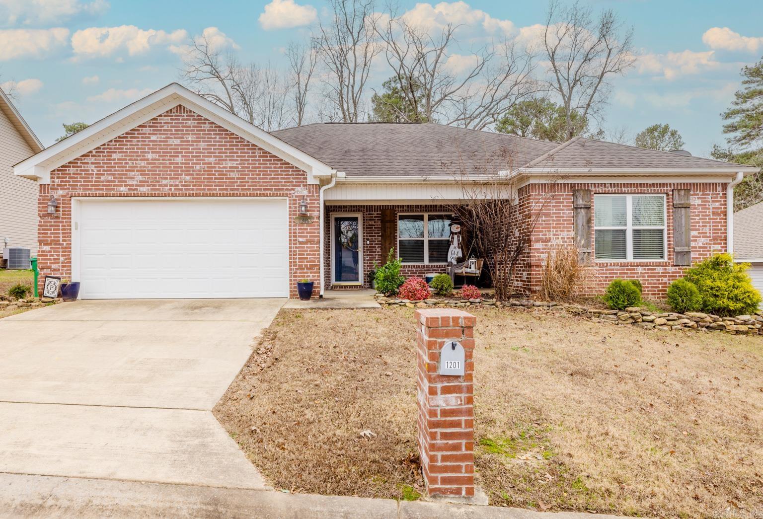 Beautiful 4 bedroom, 2 bath home in the heart of Benton! Split floor plan with the Master Suite separate from the other 3 bedrooms. Gorgeous kitchen with granite countertops, a pantry, an eat-in kitchen dining area, an island with drawers and breakfast bar seating. The kitchen opens up to the comfortable living area with a beautiful tray ceiling and electric fireplace. The Master Suite includes a spacious walk-in closet, tiled shower, clawfoot tub, granite counters and built-in shelves. The 2nd bathroom has granite counters with a large cabinet perfect for storage. Beautiful engineered hardwoods in main areas, tile & granite in both bathrooms & carpet in the bedrooms. Nice fenced backyard with large patio and covered pergola perfect for entertaining or relaxing. Large inviting front porch with a swing. Conveniently located near Benton Schools, shopping, medical facilities, restaruants, and the interstate for an easy commute. This home is in excellent condition and ready for it's new owners. Schedule your showing today!