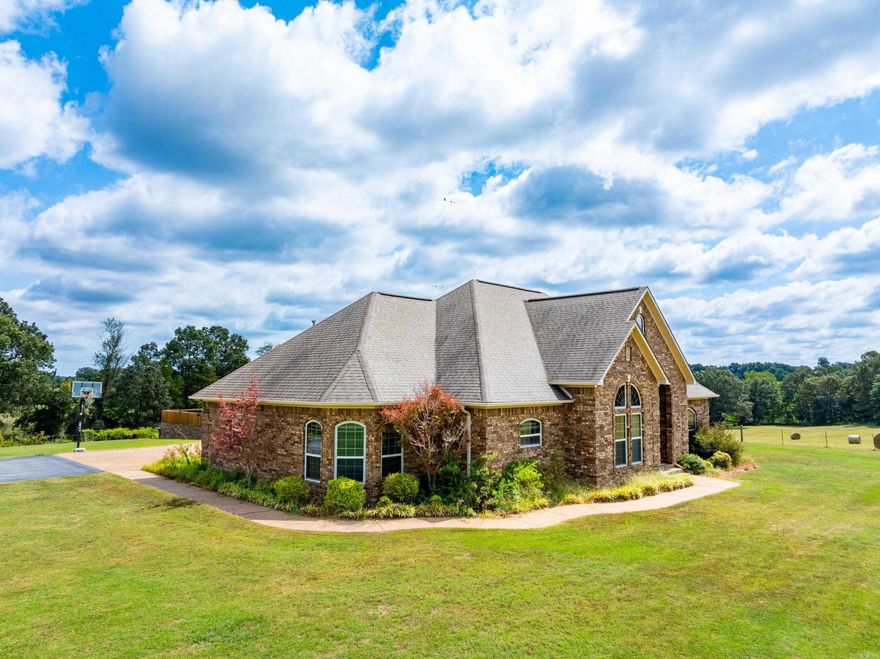 Stunning 4-Bedroom Estate on 18 +/- Acres – Cave City, Arkansas This brick estate is a showplace! Sitting on 18 acres just north of Cave City, it offers over 4,500 +/- sq ft under roof with 3,700 +/- heated/cooled sq ft, a full basement, outdoor living, and space for horses or cattle. Built in 2008, the home features a 2-car garage with unfinished bonus space, a formal dining room, spacious living room with gas fireplace and built-ins, and a gorgeous kitchen with custom cabinets and breakfast nook. The large primary suite includes double vanities, his & hers closets, jetted tub, and tiled shower. Three more bedrooms, full bath, mudroom, laundry, and screened porch complete the main level. The finished basement offers a family room, kitchenette, bath, office, storage, and a heated/cooled safe room. Outdoors, enjoy a pool with deck, pool house with bathroom, and a covered outdoor kitchen. Acreage is fenced, hay-producing, and livestock-ready. Manicured lawn, mature trees, and privacy make this property a dream! This home was custom built in 2008, pasture is gorgeous! There is more land, shop and additional 5 +/- Acres that can be purchased with this or have first right of refusal on.